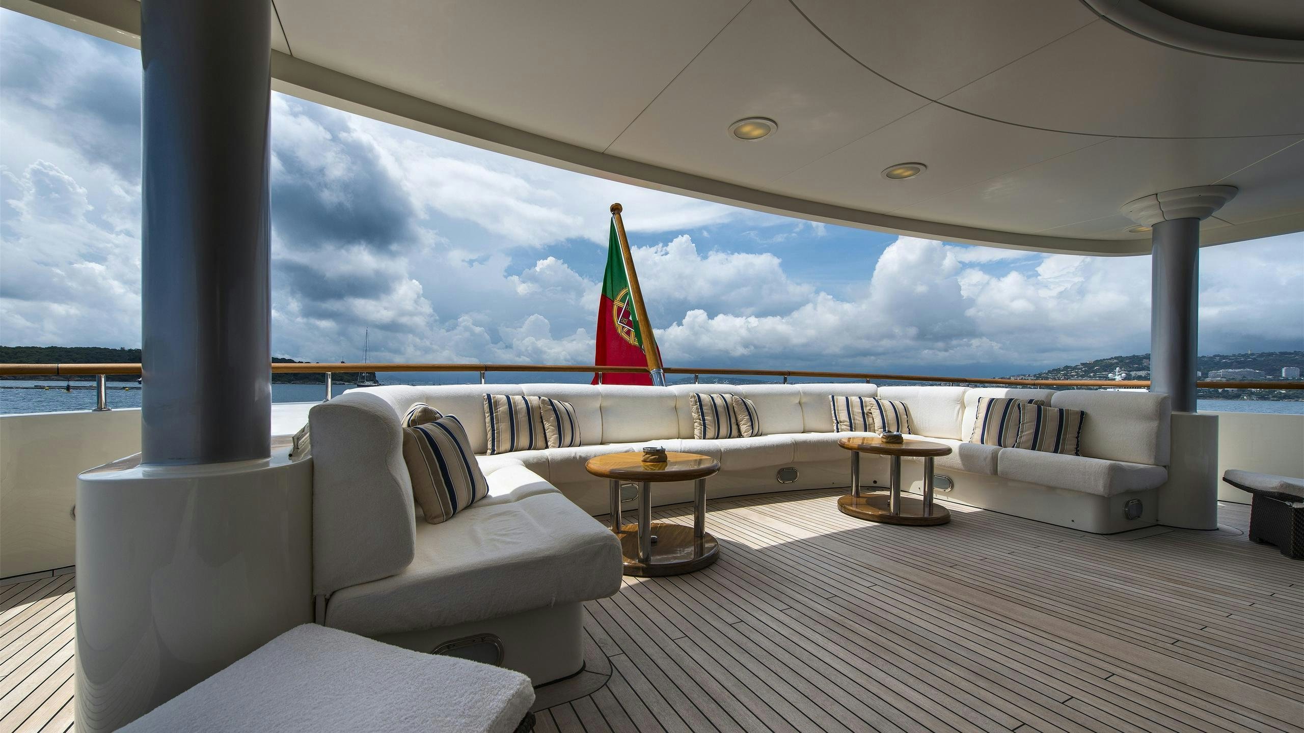 a large white lounge chair in a room with a large window aboard SOLAFIDE Yacht for Charter