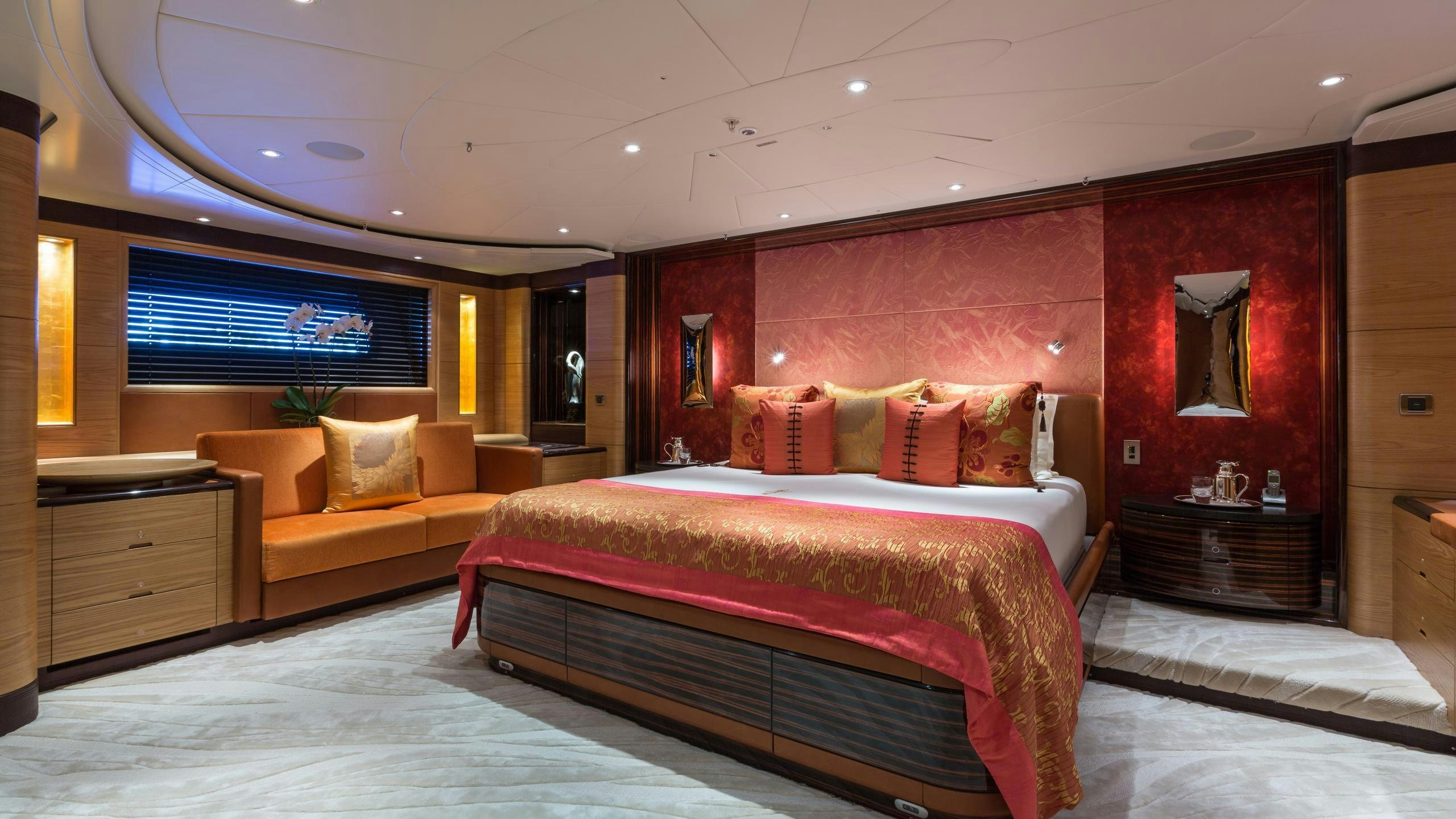 a bedroom with a bed and a couch aboard Q Yacht for Charter