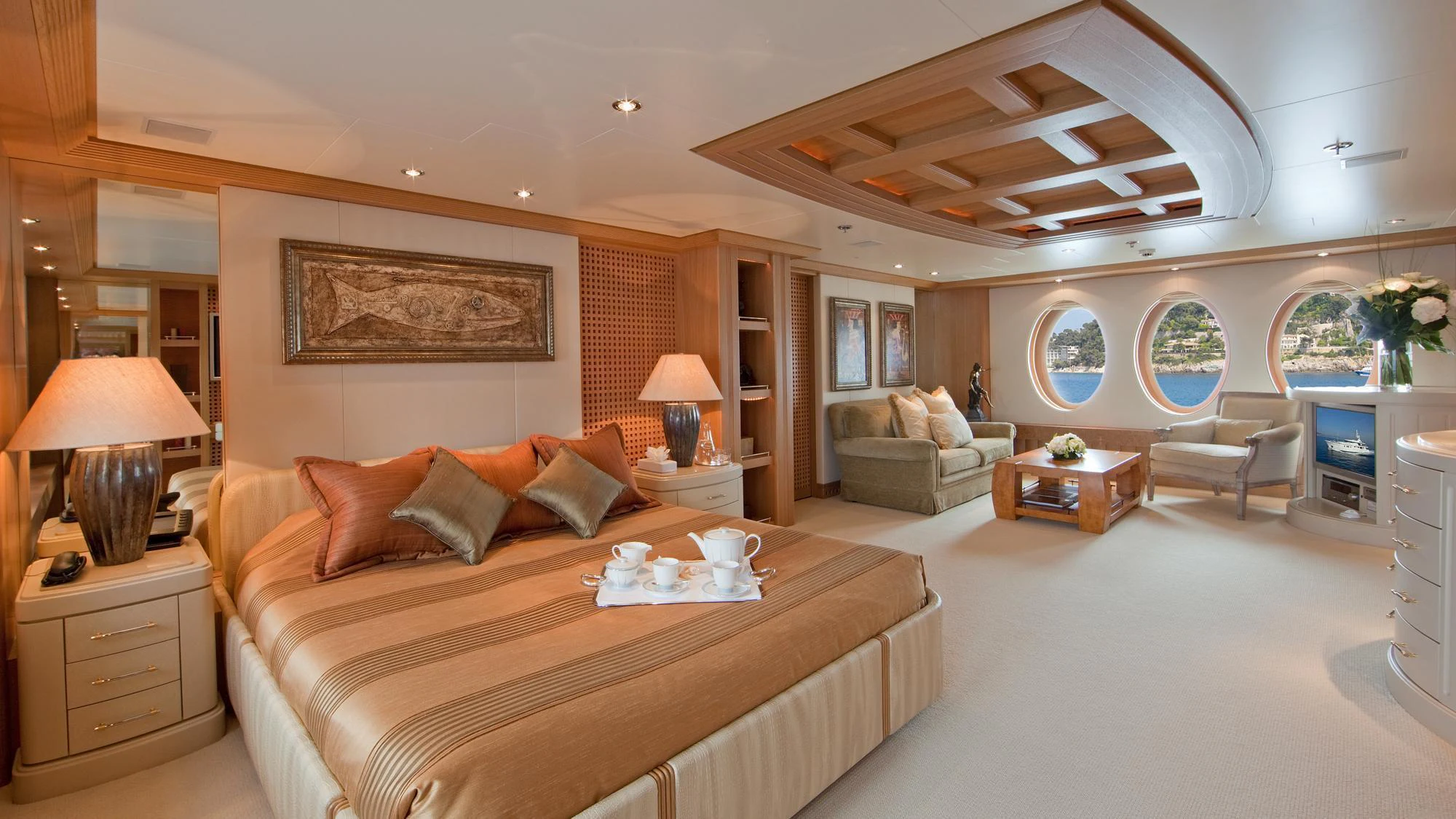 a large bedroom with a bed and a couch aboard DEJA TOO Yacht for Charter