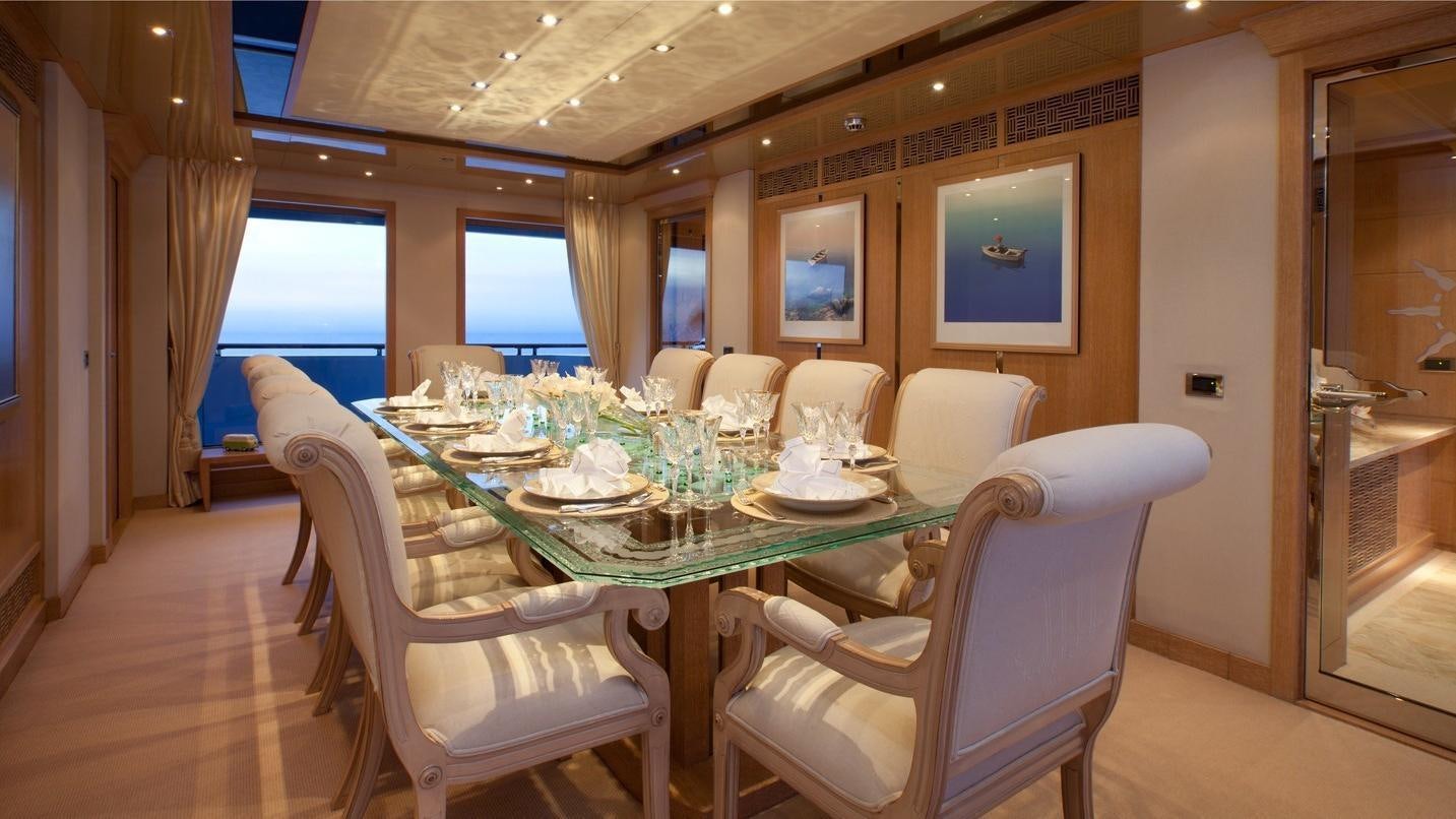 a dining room with a table and chairs aboard FRIENDSHIP Yacht for Charter