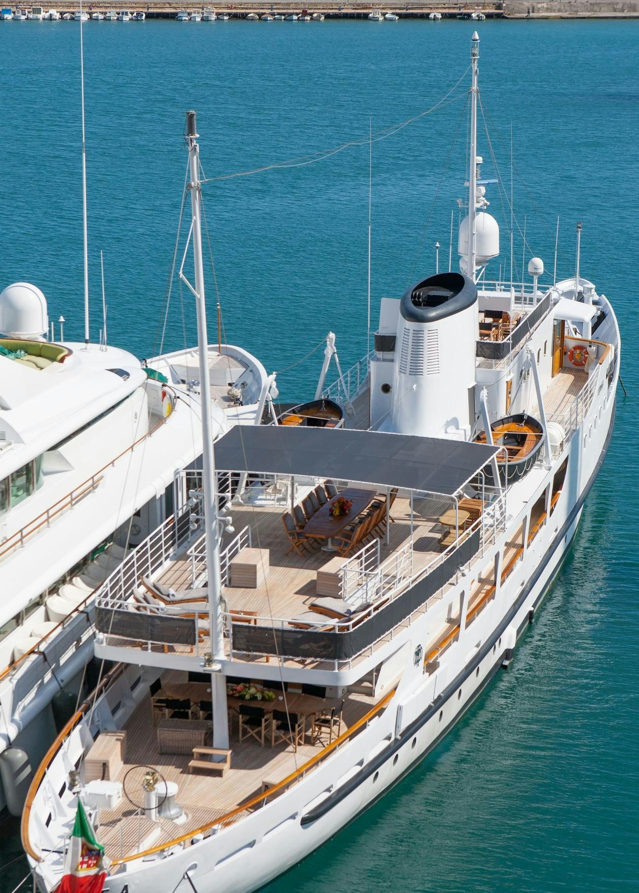 a boat docked at a pier aboard DIONEA Yacht for Charter