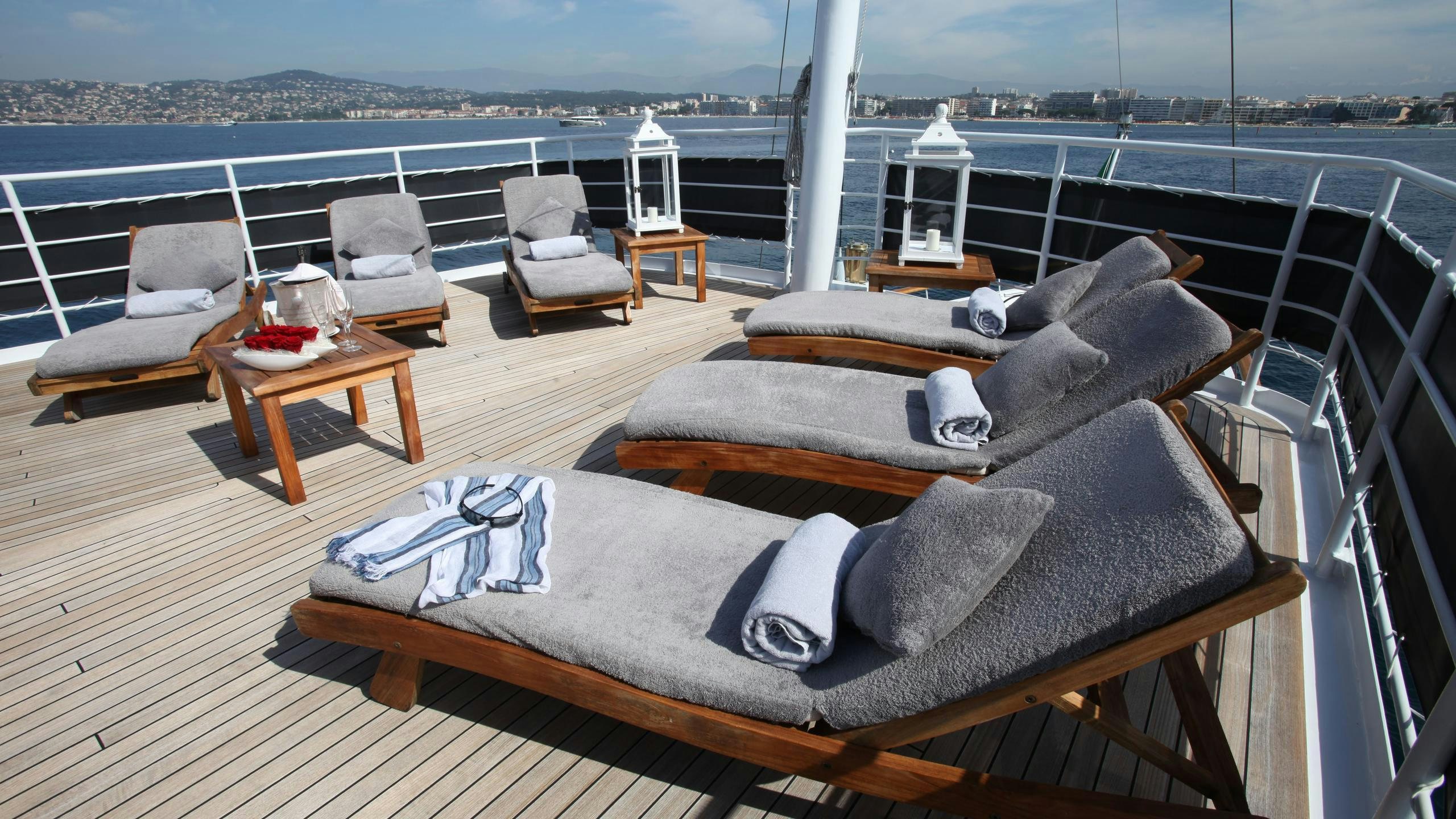 a large bed on a deck aboard DIONEA Yacht for Charter