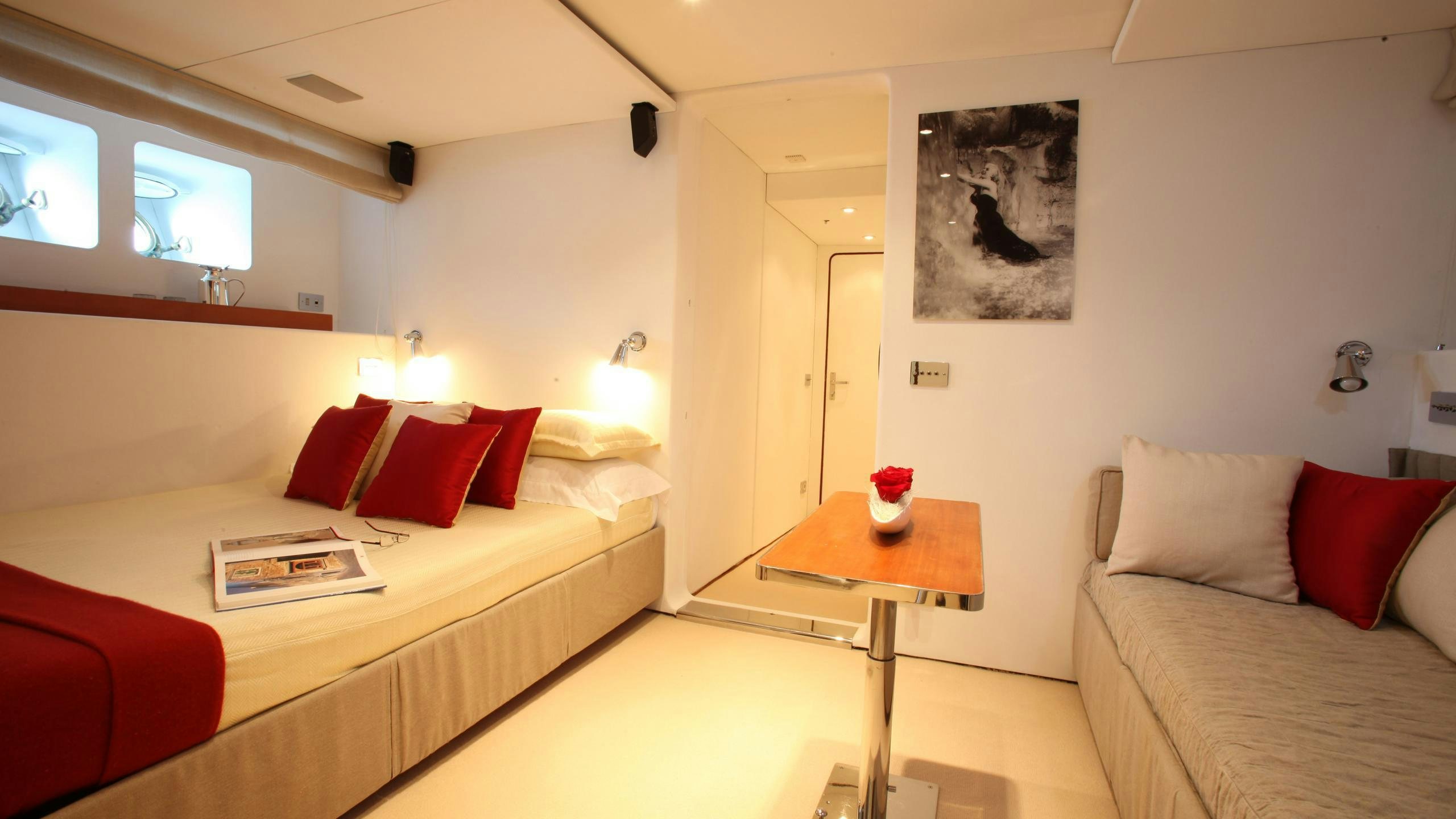 a hotel room with a bed and a desk aboard DIONEA Yacht for Charter