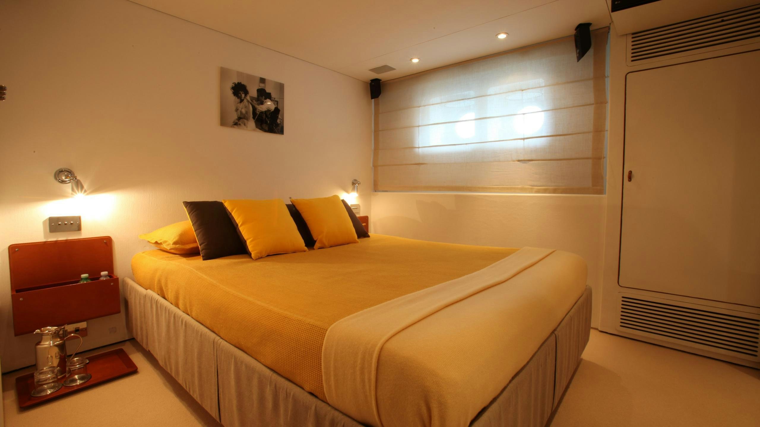 a bedroom with a bed and a desk aboard DIONEA Yacht for Charter