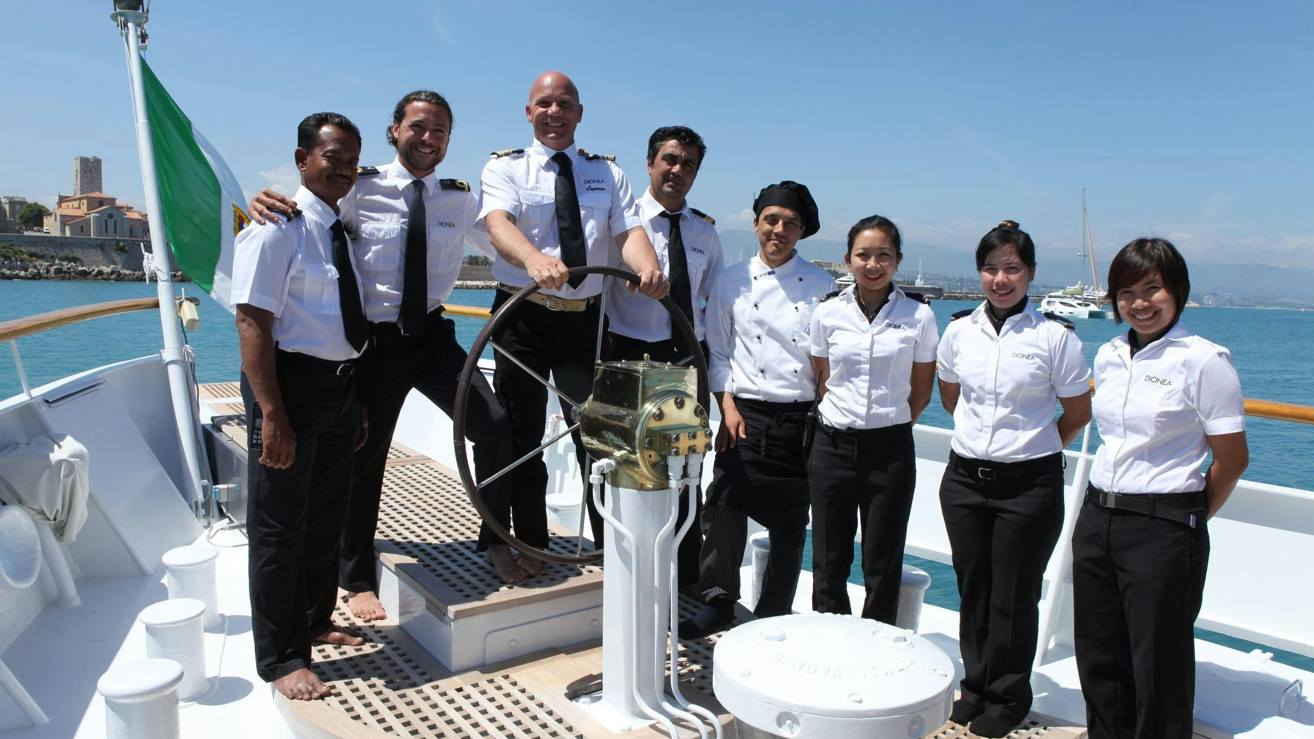 a group of people posing for a photo aboard DIONEA Yacht for Charter