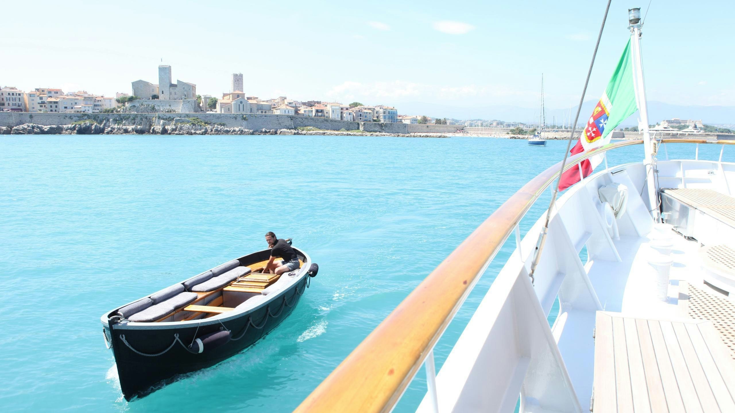 a boat with a person on it aboard DIONEA Yacht for Charter