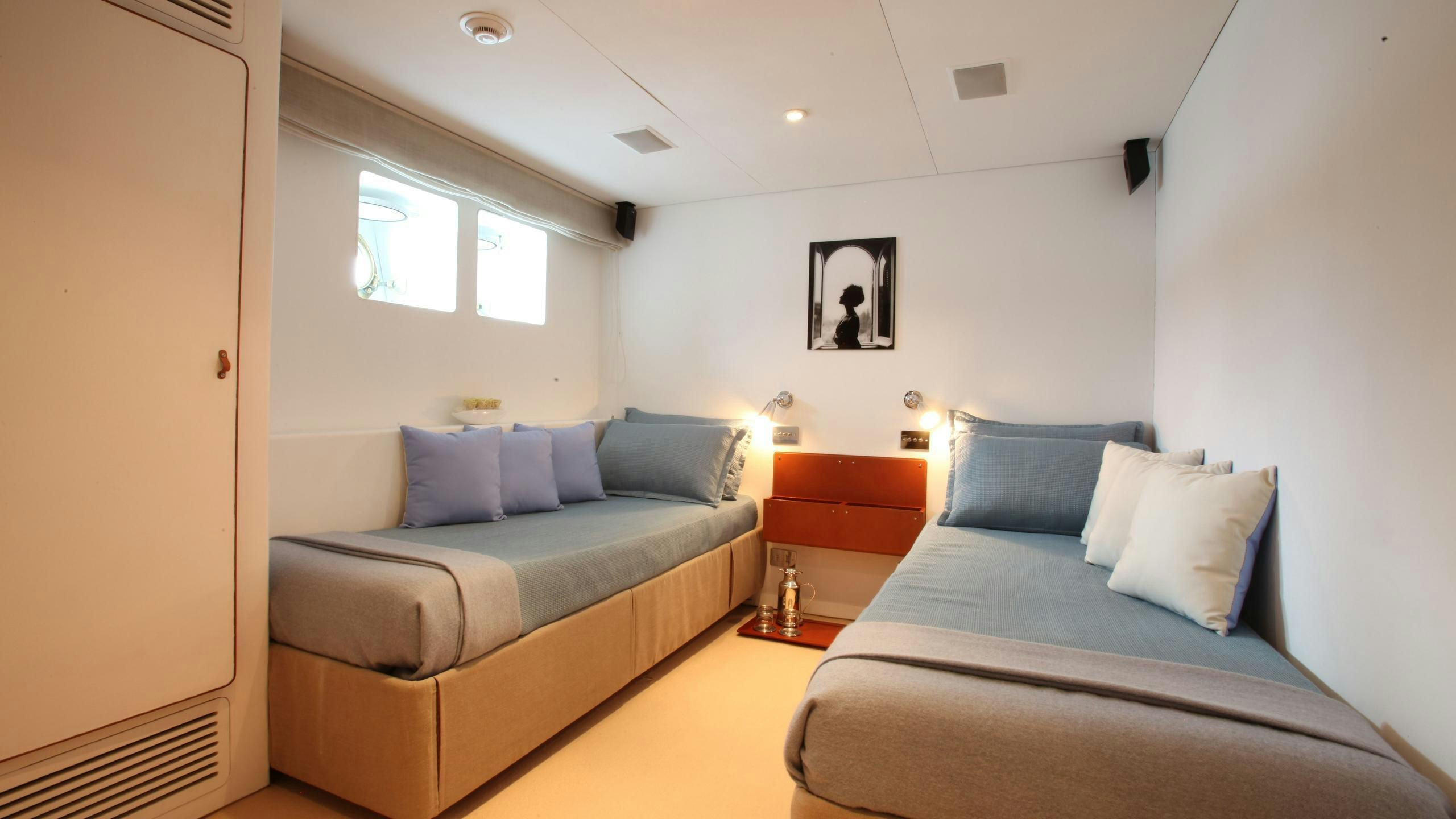 a room with a couch and a bed aboard DIONEA Yacht for Charter