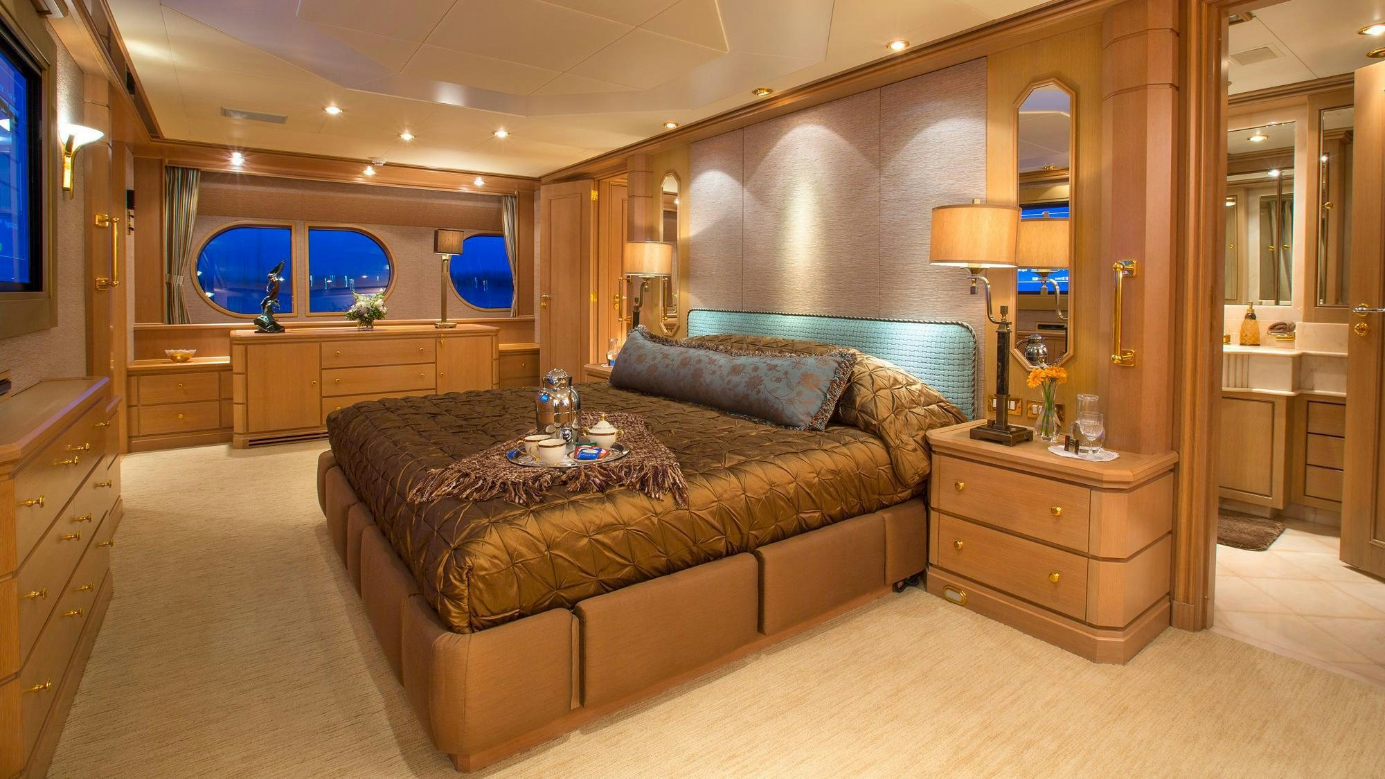 a bedroom with a bed and a desk aboard CHANTAL MA VIE Yacht for Charter