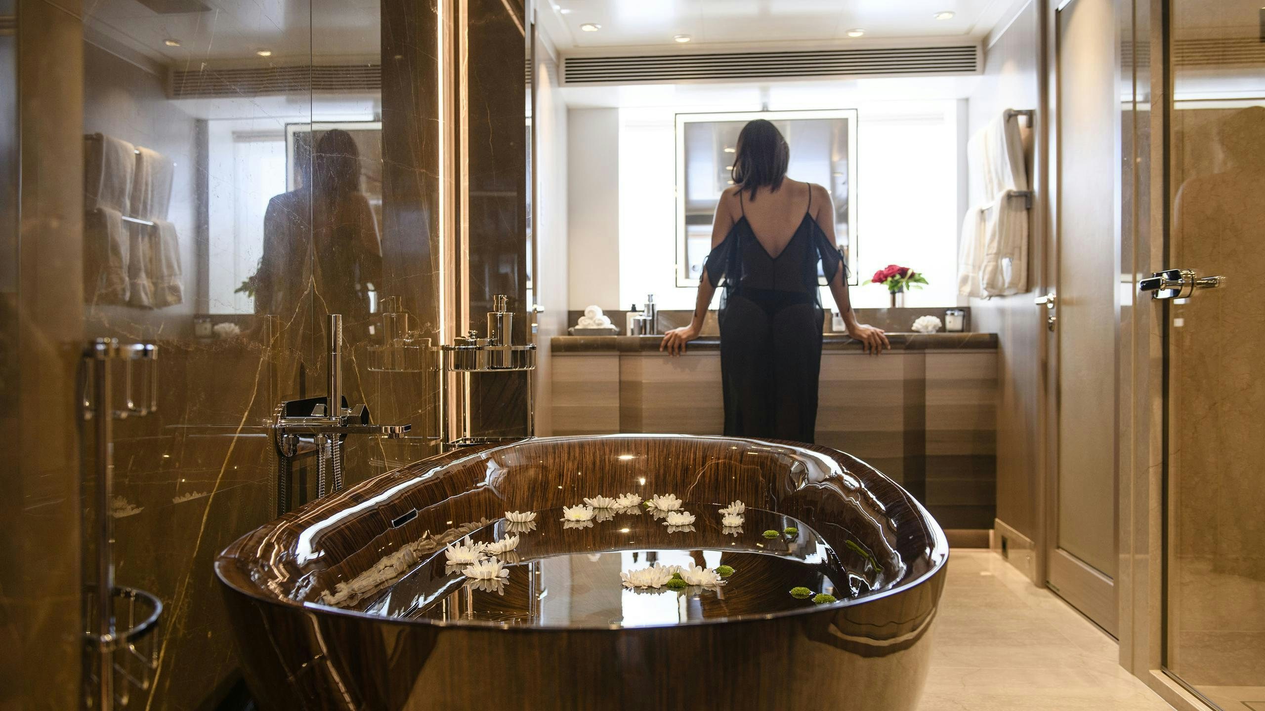 a person standing in a bathroom aboard IRISHA Yacht for Charter