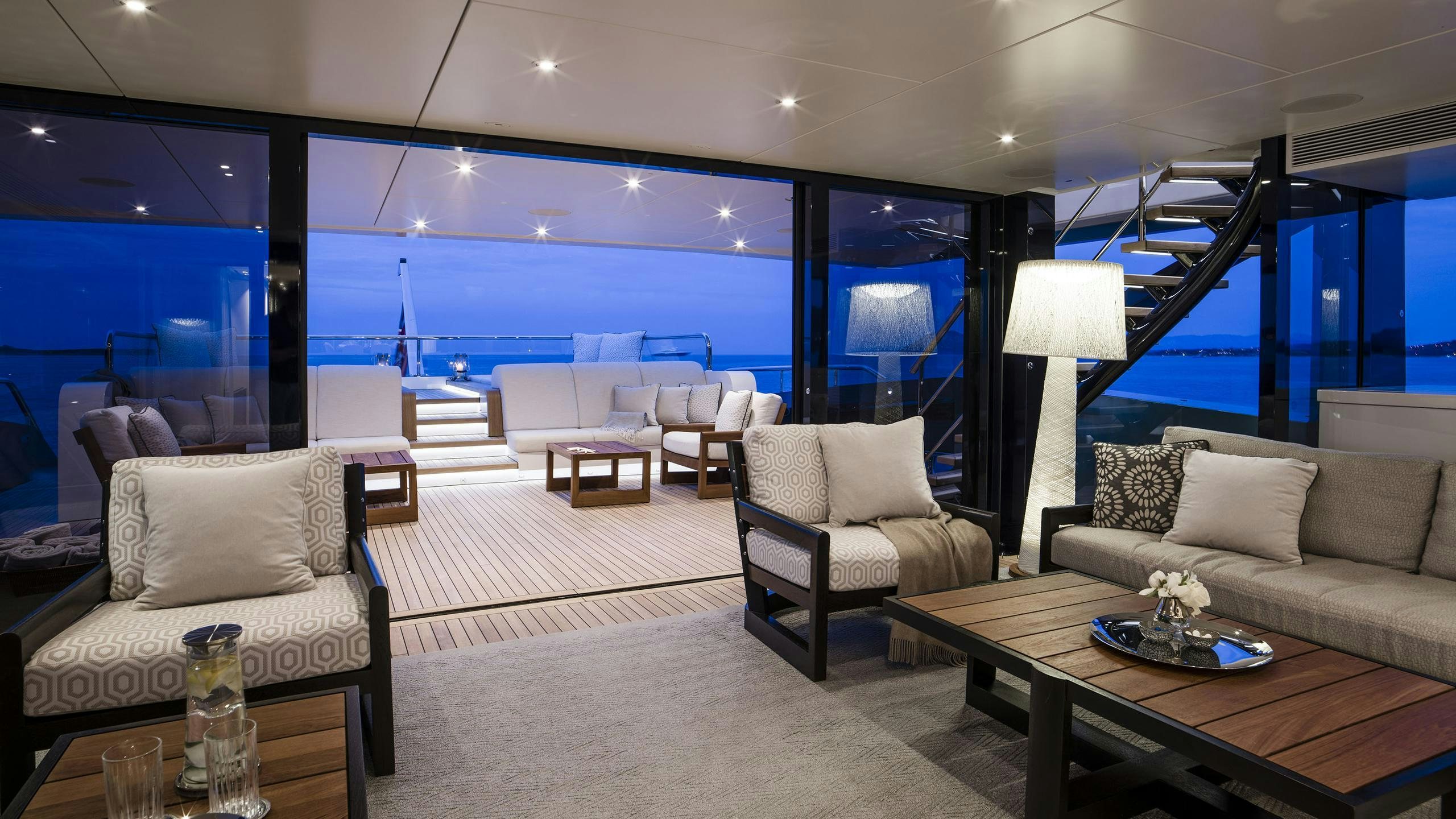 a living room with a large window aboard IRISHA Yacht for Charter