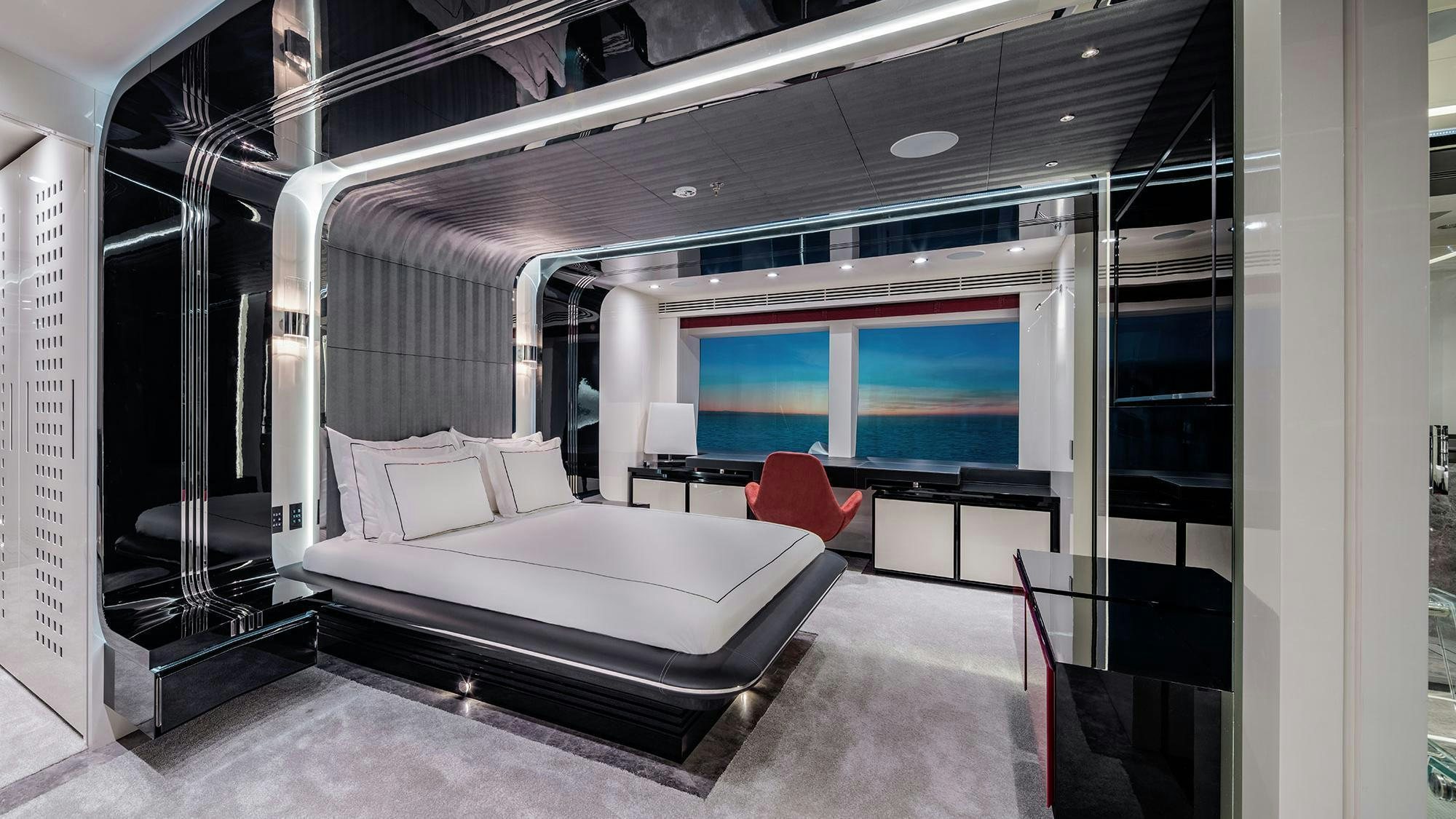 a room with a bed and a window aboard EUPHORIA II Yacht for Charter