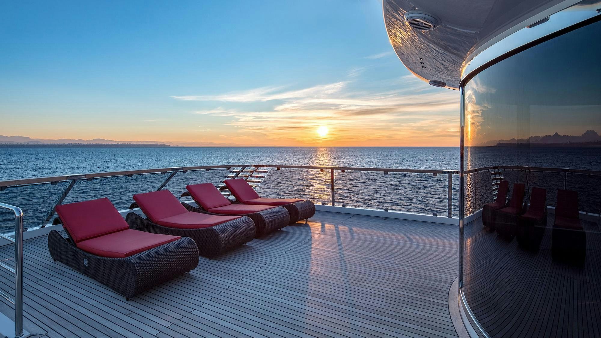 a deck with chairs on it by the water aboard EUPHORIA II Yacht for Charter