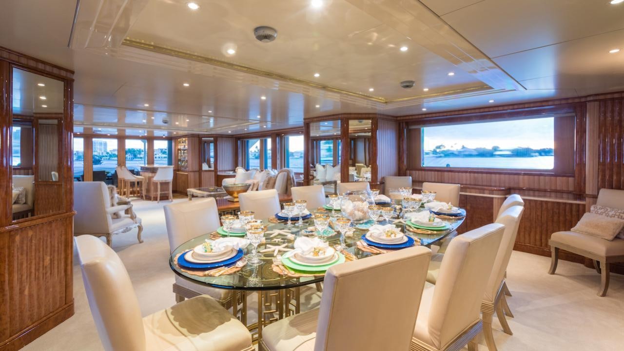 a large room with a table and chairs aboard BARENTS Yacht for Charter