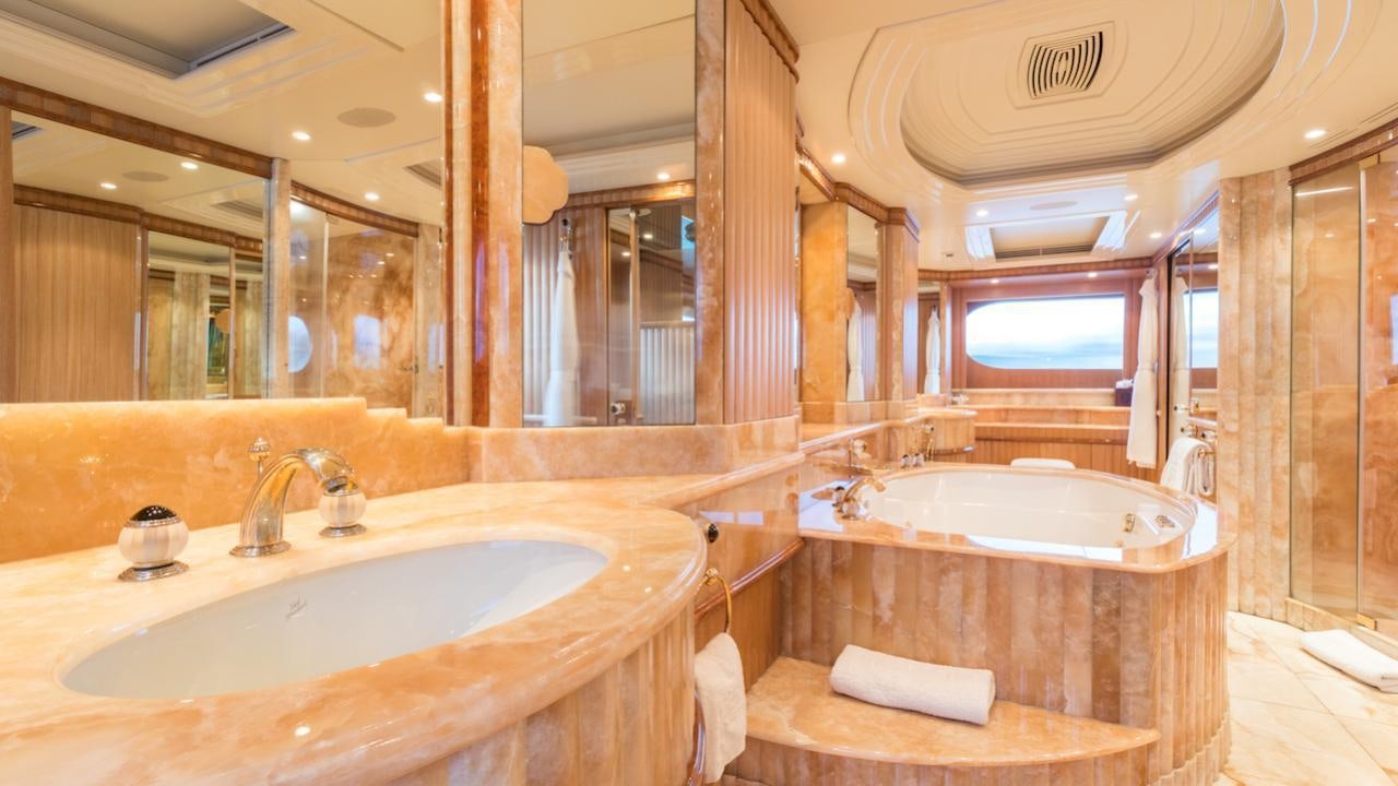 a bathroom with a tub sink and a sink aboard BARENTS Yacht for Charter