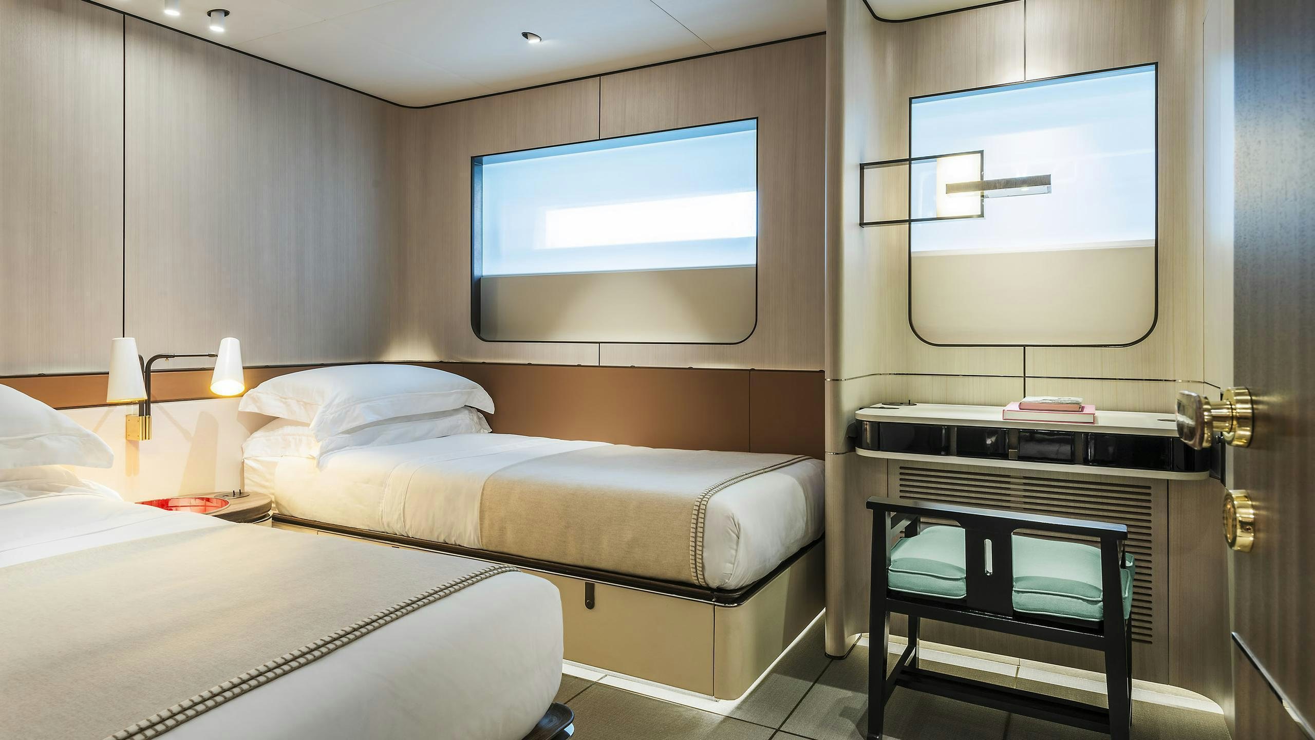 a room with two beds and a tv aboard ENDEAVOUR 2 Yacht for Charter
