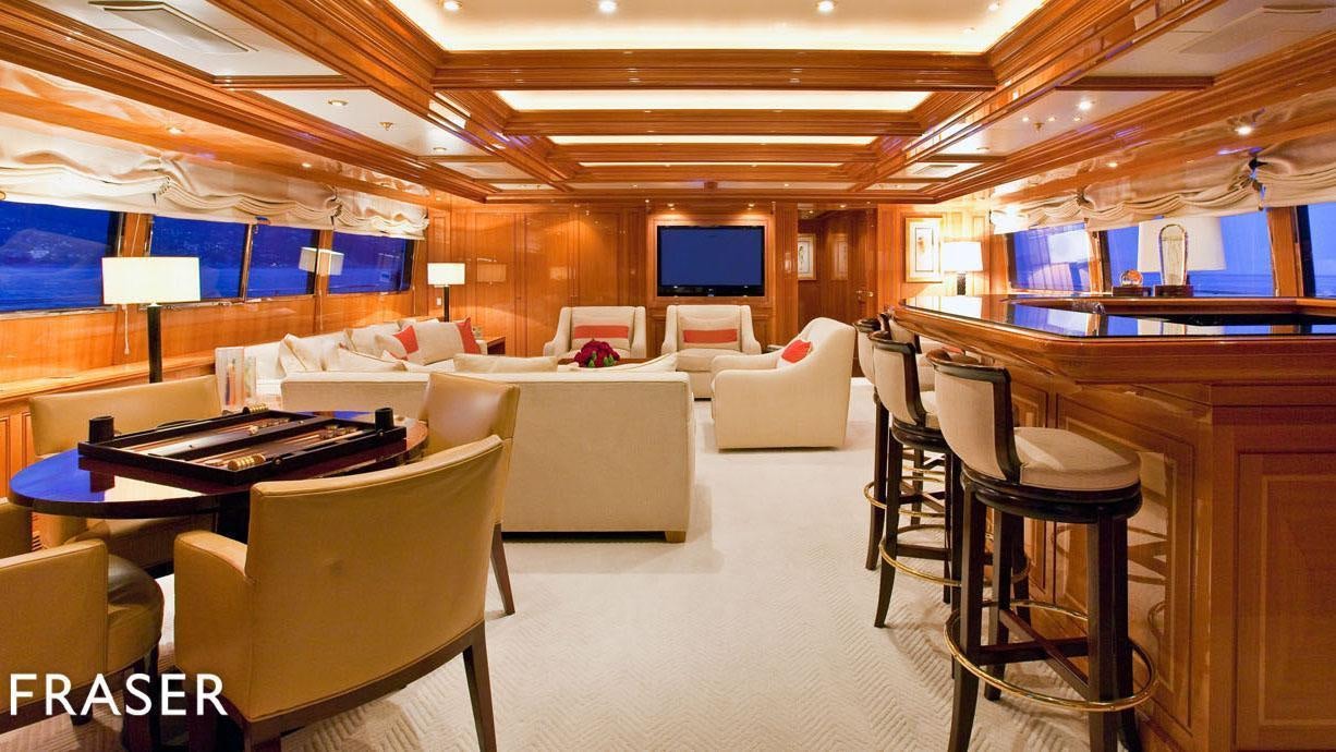 a room with a table chairs and a couch aboard ELENA V Yacht for Charter