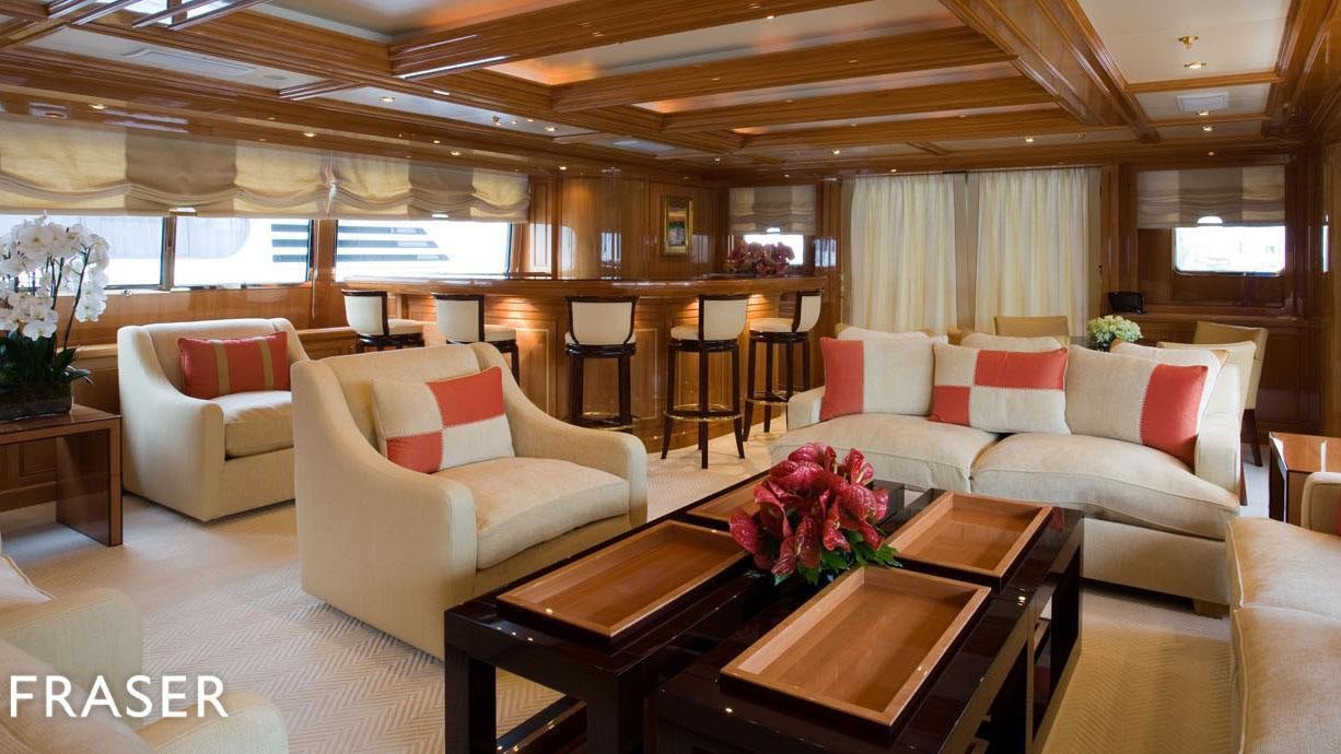 a living room with a table and couches aboard ELENA V Yacht for Charter