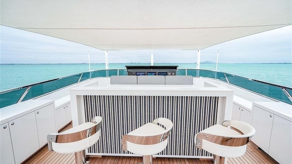 a white room with a table and chairs on a deck aboard (DELETE)INCOGNITO Yacht for Charter