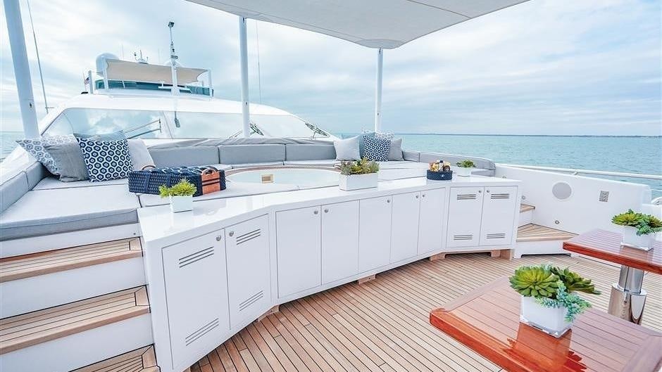 a white kitchen with a large white island and a large white boat in the background aboard (DELETE)INCOGNITO Yacht for Charter