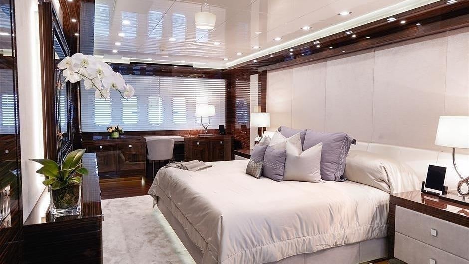 a bedroom with a bed and a desk aboard (DELETE)INCOGNITO Yacht for Charter