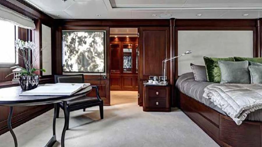 a room with a bed and a table aboard AZTECA Yacht for Charter