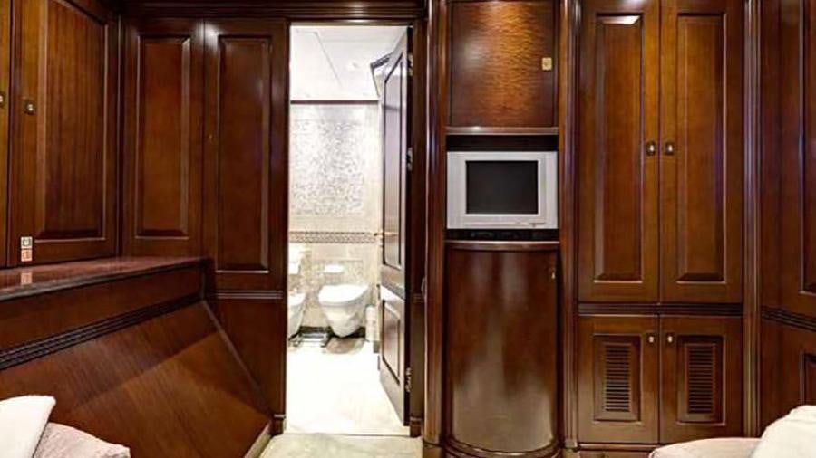 a room with wooden cabinets and a refrigerator aboard AZTECA Yacht for Charter