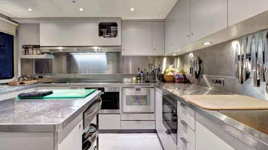 a kitchen with white cabinets aboard AZTECA Yacht for Charter