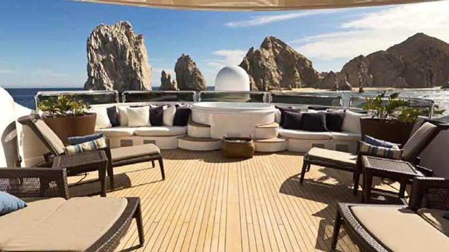 a deck with chairs and tables aboard AZTECA Yacht for Charter