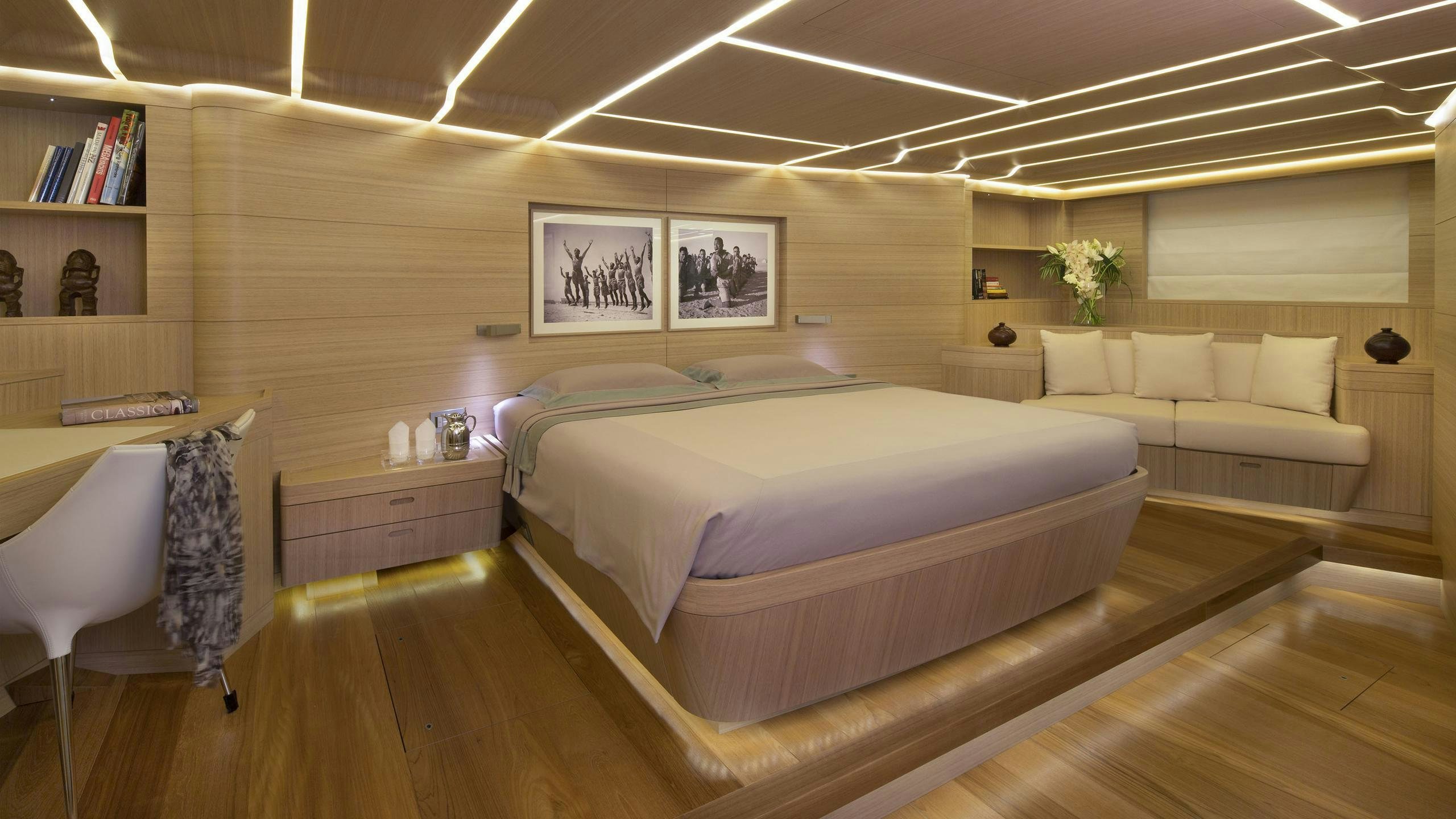 a room with a bed and a couch aboard OHANA Yacht for Charter
