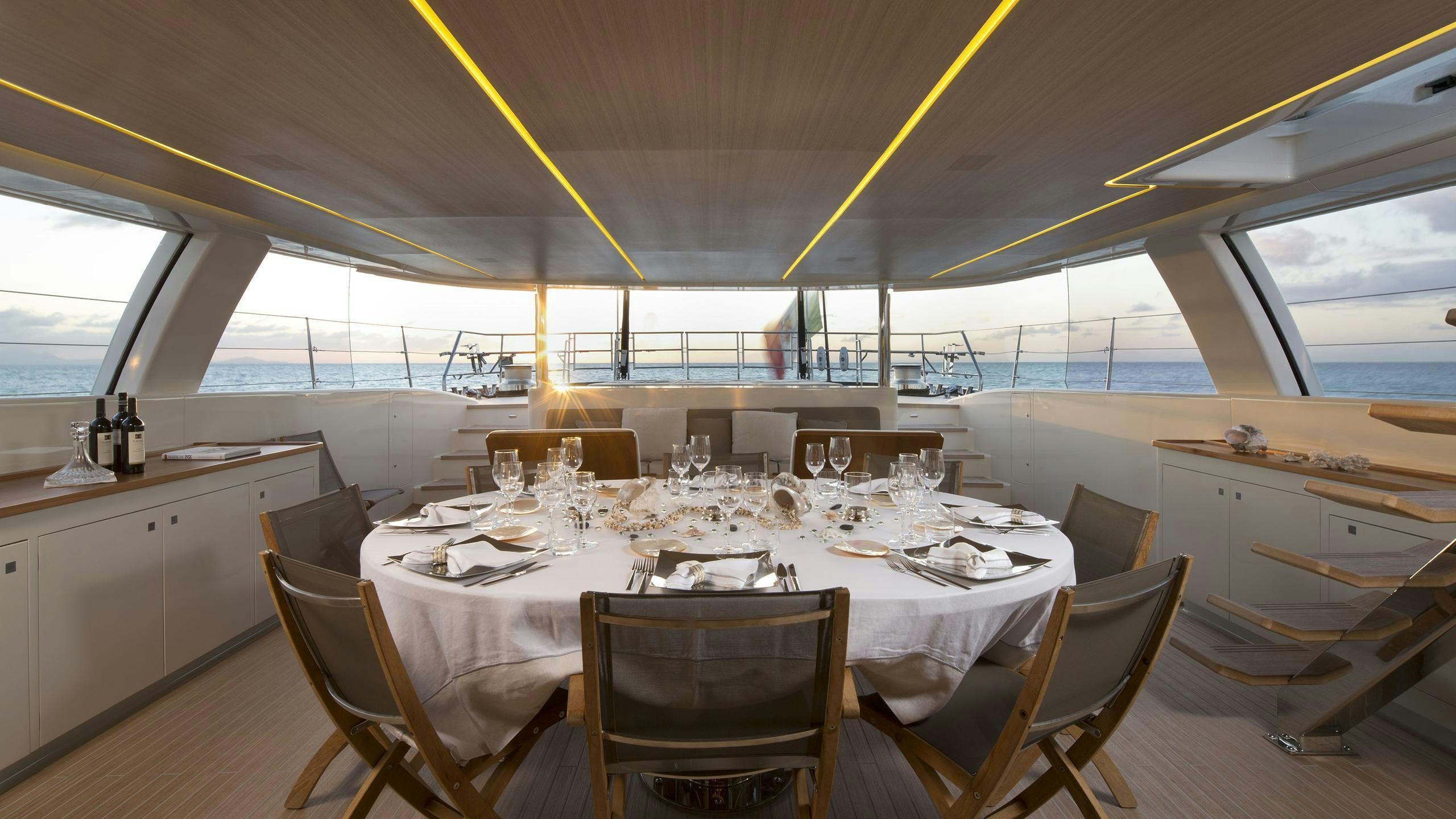 a dining room with a table set for a meal aboard OHANA Yacht for Charter