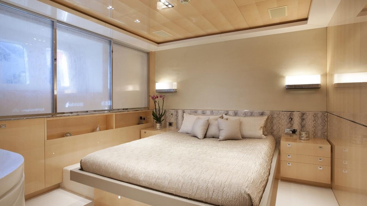 a room with a bed and a window aboard LA PELLEGRINA 1 Yacht for Charter
