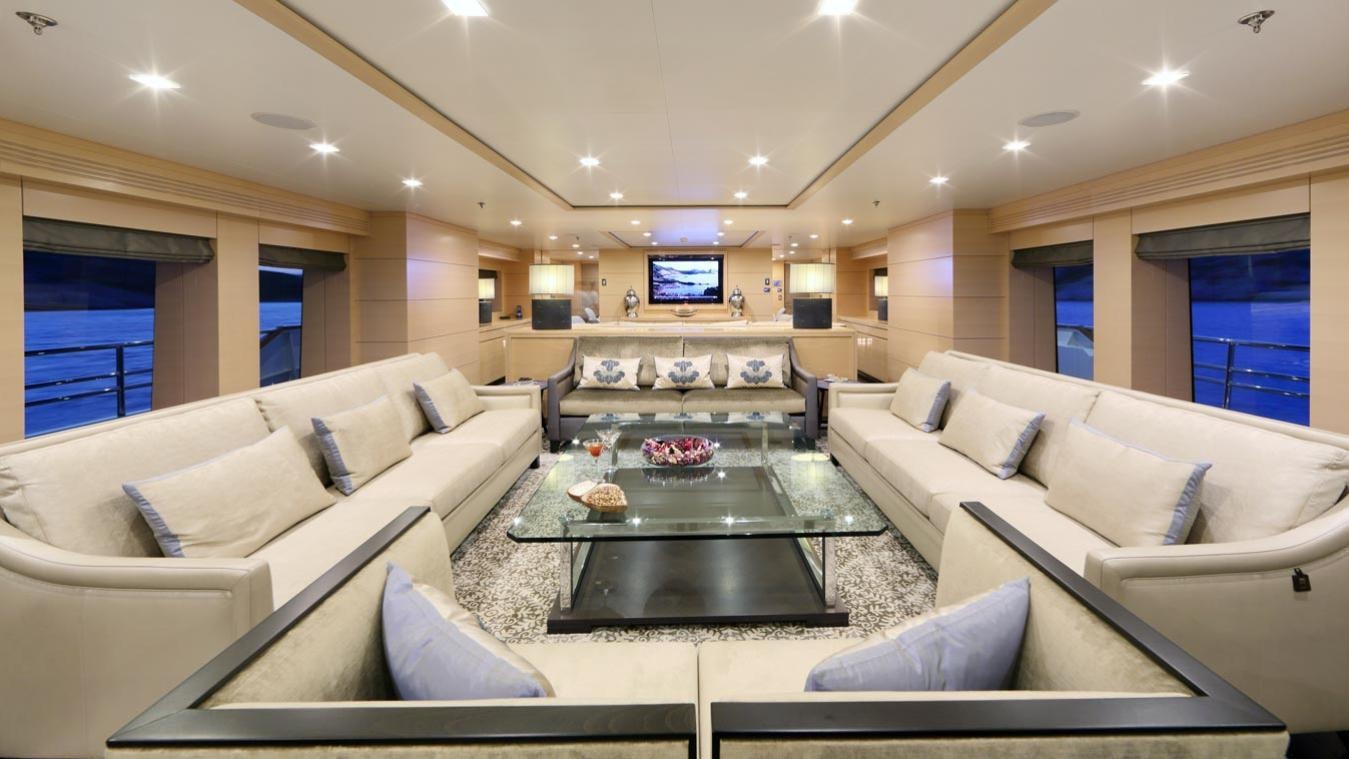 a living room with a large sofa aboard EGO Yacht for Charter