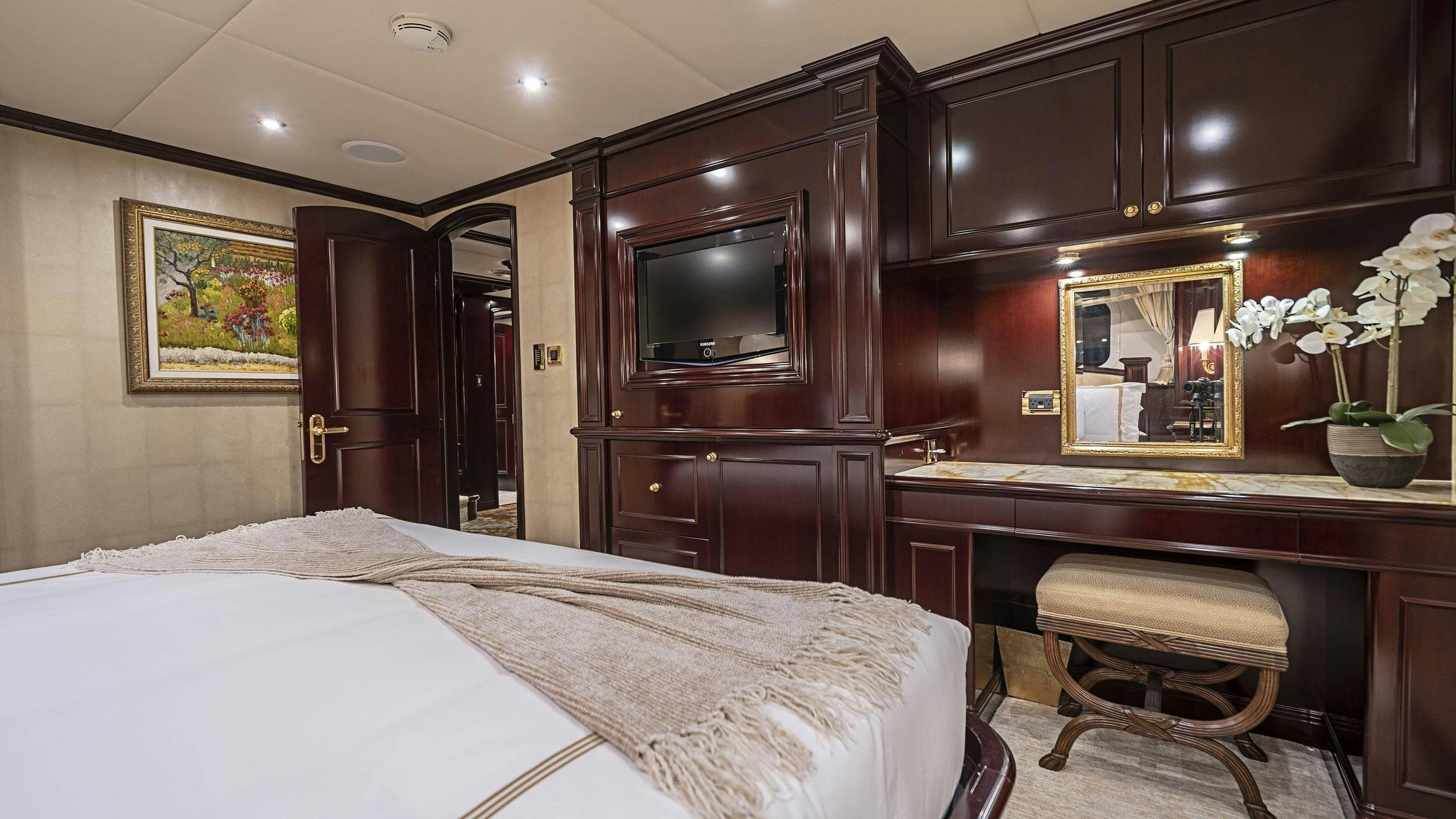 a hotel room with a bed and a mirror aboard MISS CHRISTINE Yacht for Charter