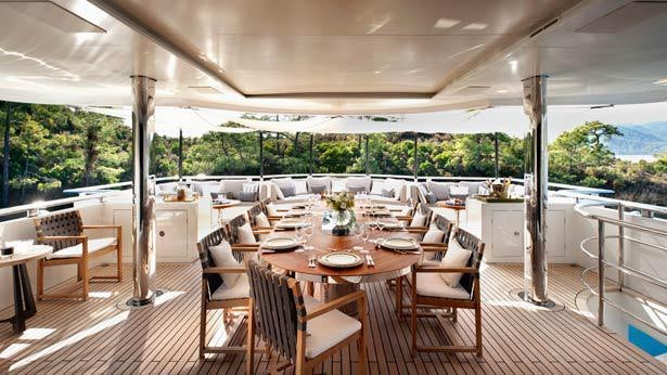 a room with tables and chairs aboard ORIENT STAR Yacht for Charter