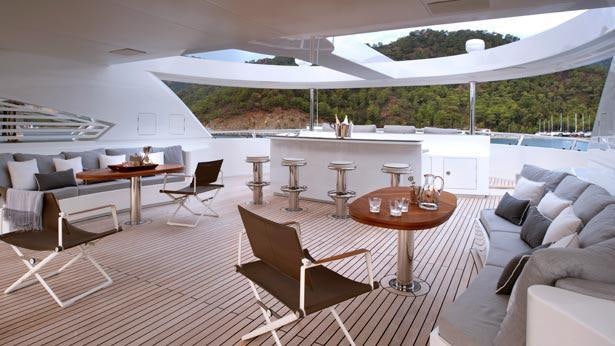 a large room with a table and chairs and a large white tent aboard ORIENT STAR Yacht for Charter