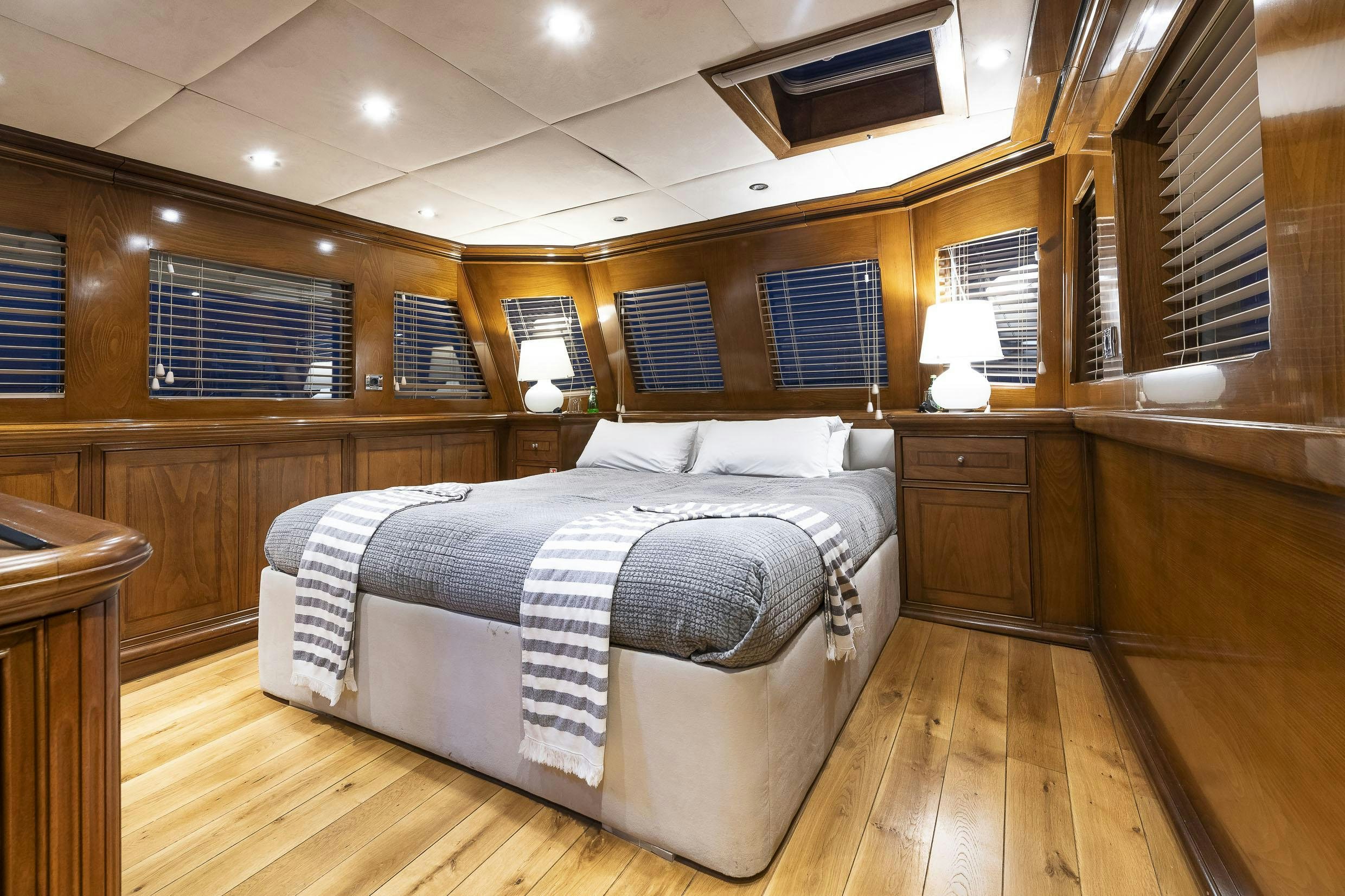 a bedroom with a bed and a window aboard 2 LADIES Yacht for Charter
