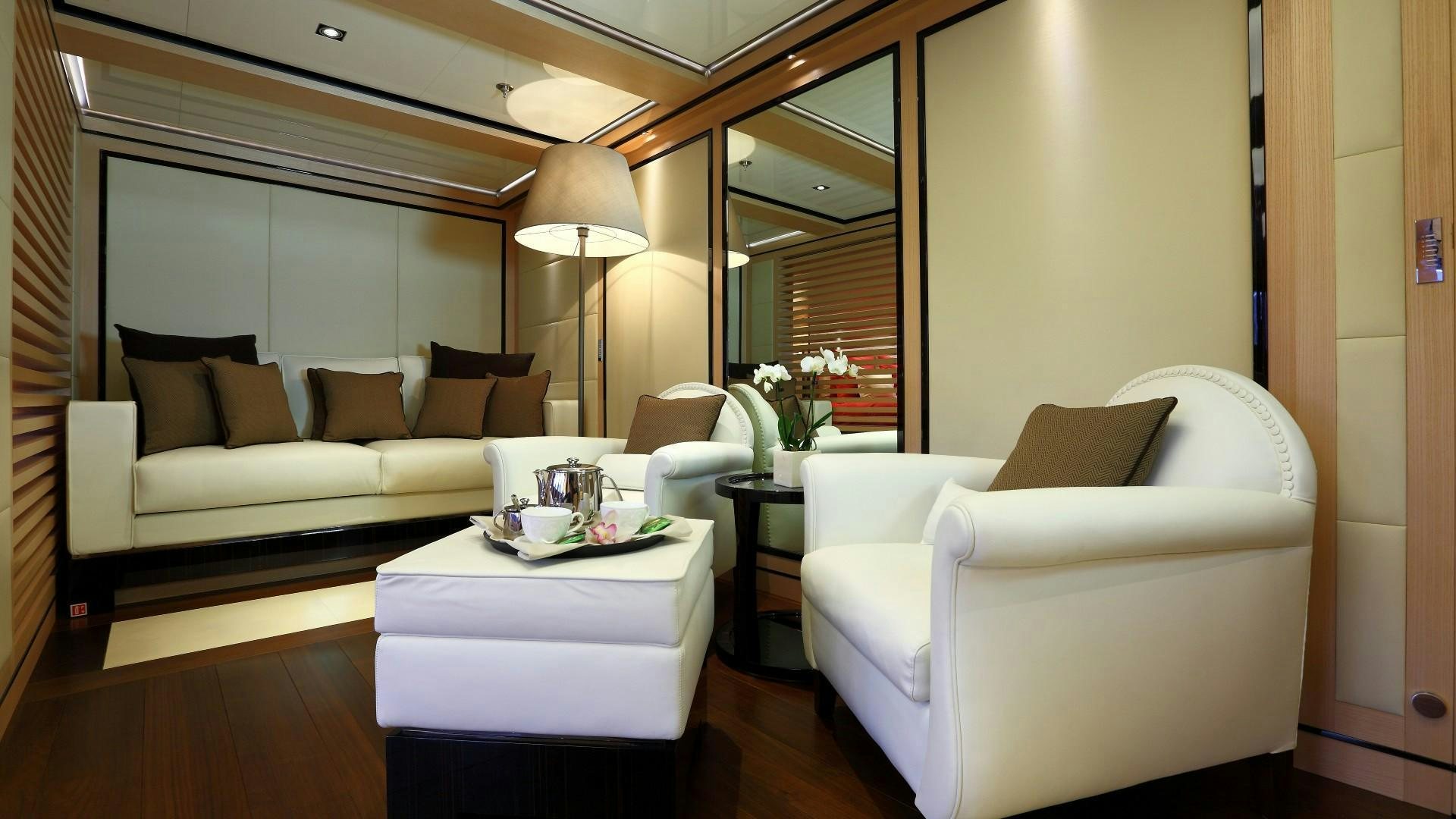 a living room with a couch and a table aboard 2 LADIES Yacht for Charter
