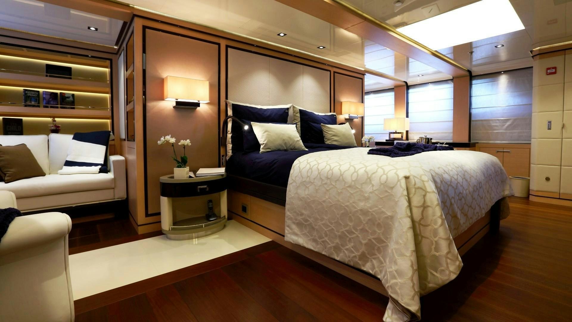 a bedroom with a bed and a couch aboard 2 LADIES Yacht for Charter