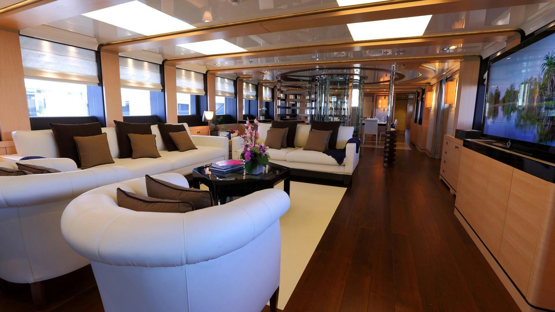 a room with couches and a television aboard 2 LADIES Yacht for Charter