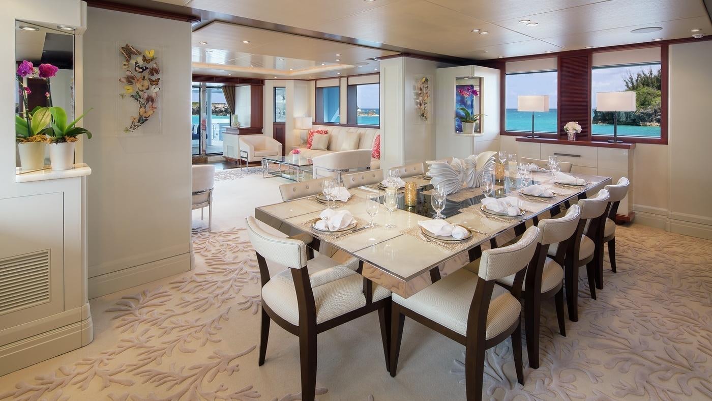 a dining room with tables and chairs aboard PISCES Yacht for Charter