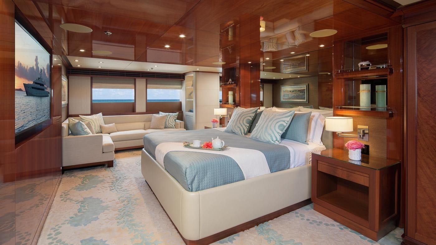 a room with a bed and a couch aboard PISCES Yacht for Charter