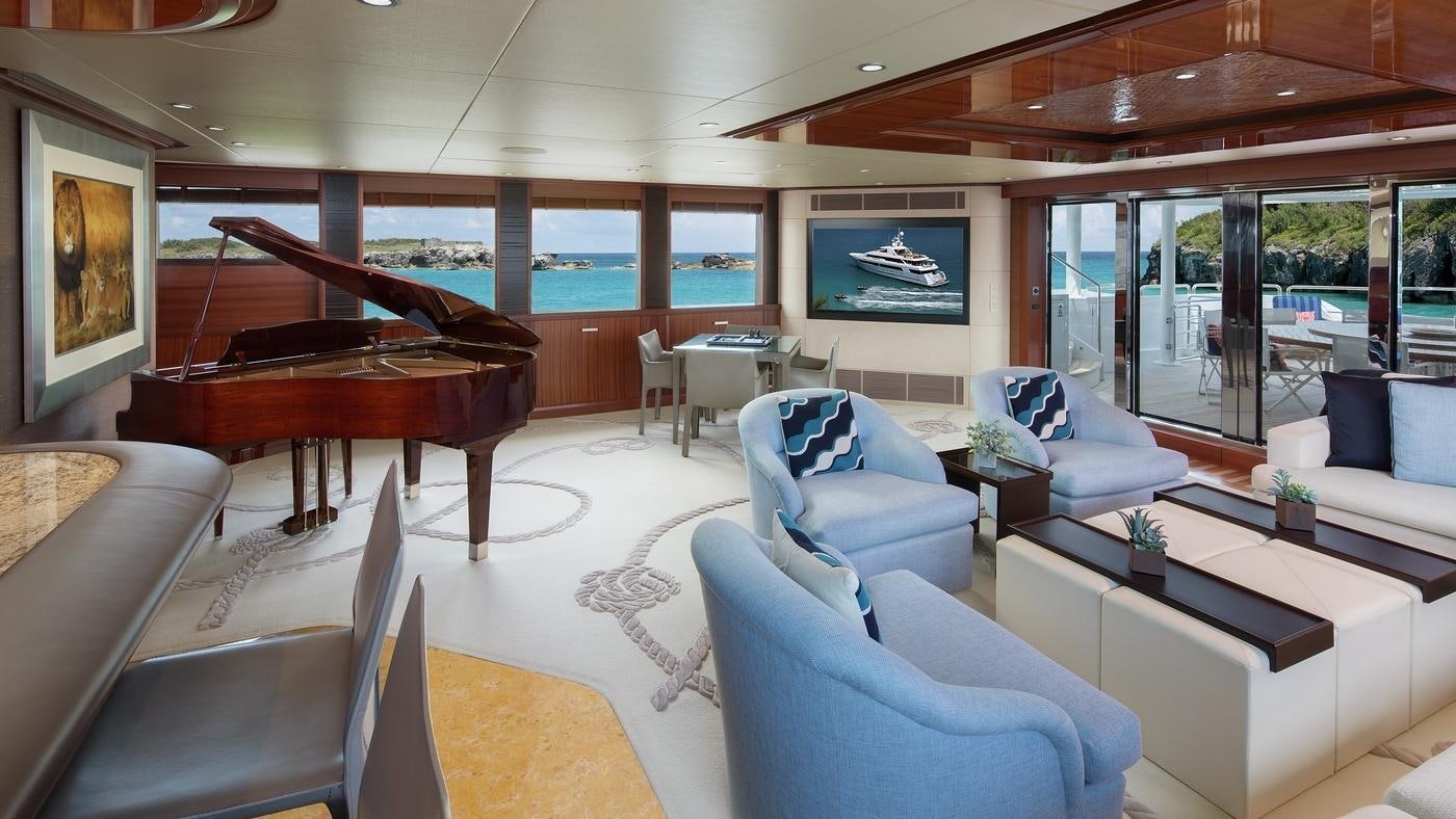 a living room with a piano aboard PISCES Yacht for Charter