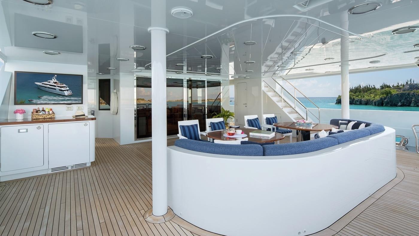 a room with a large white table and chairs and a large window aboard PISCES Yacht for Charter