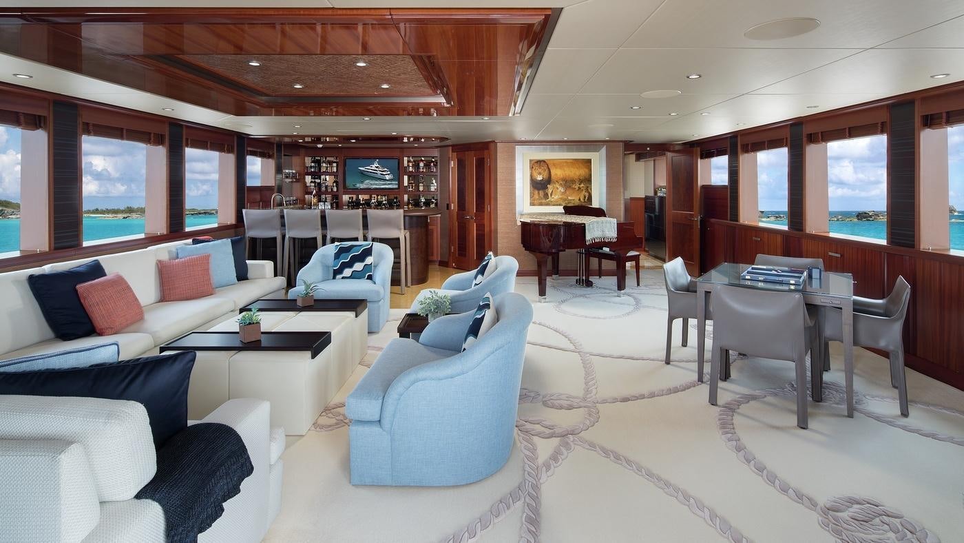 a room with a couch and a table and chairs aboard PISCES Yacht for Charter