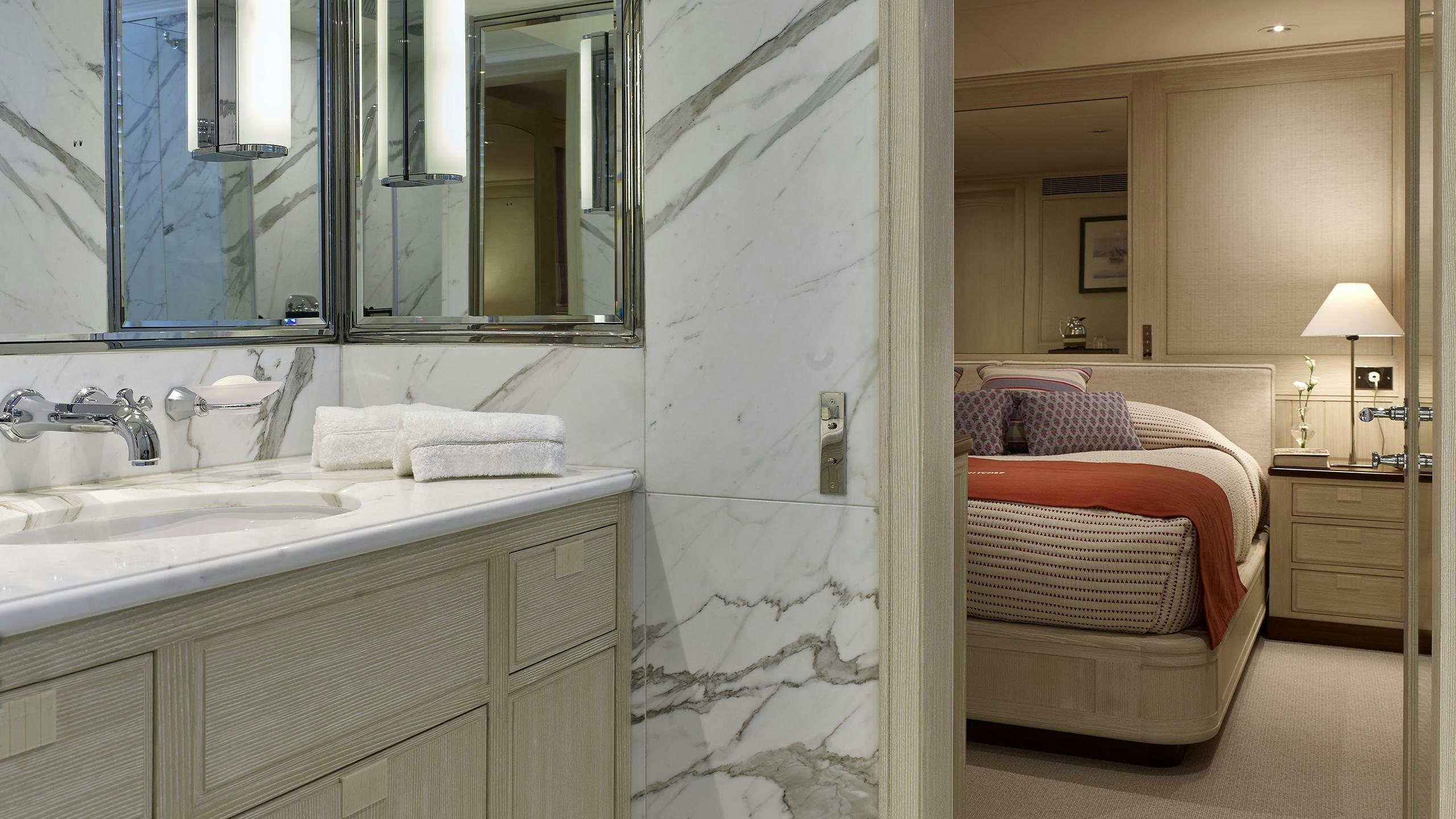 a bathroom with a sink and a bed aboard ANCALLIA Yacht for Charter