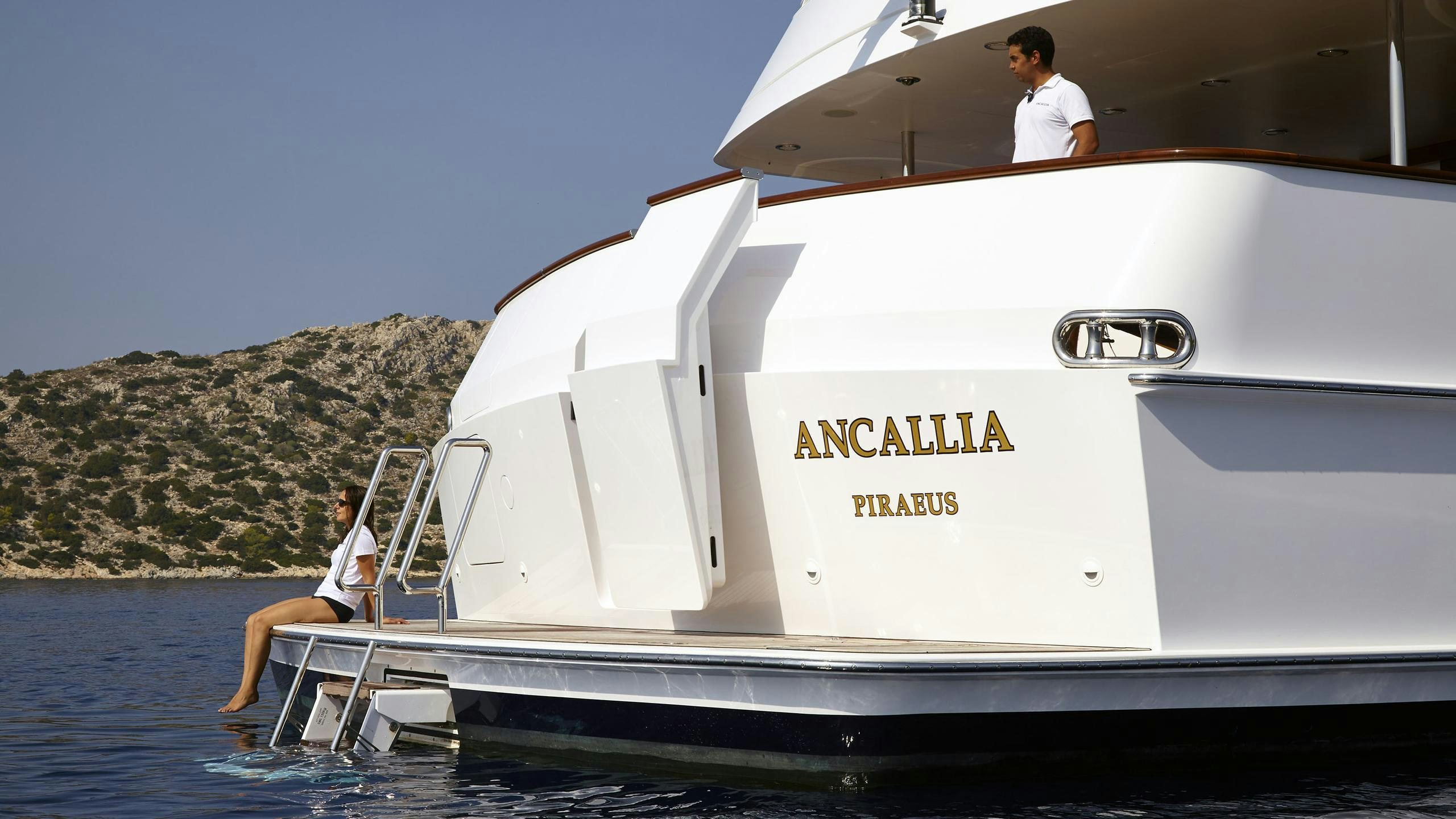 a person sitting on a boat aboard ANCALLIA Yacht for Charter