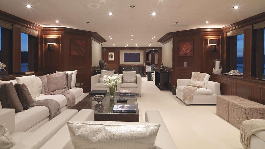 a living room with a white couch and a coffee table aboard MY LITTLE VIOLET Yacht for Charter