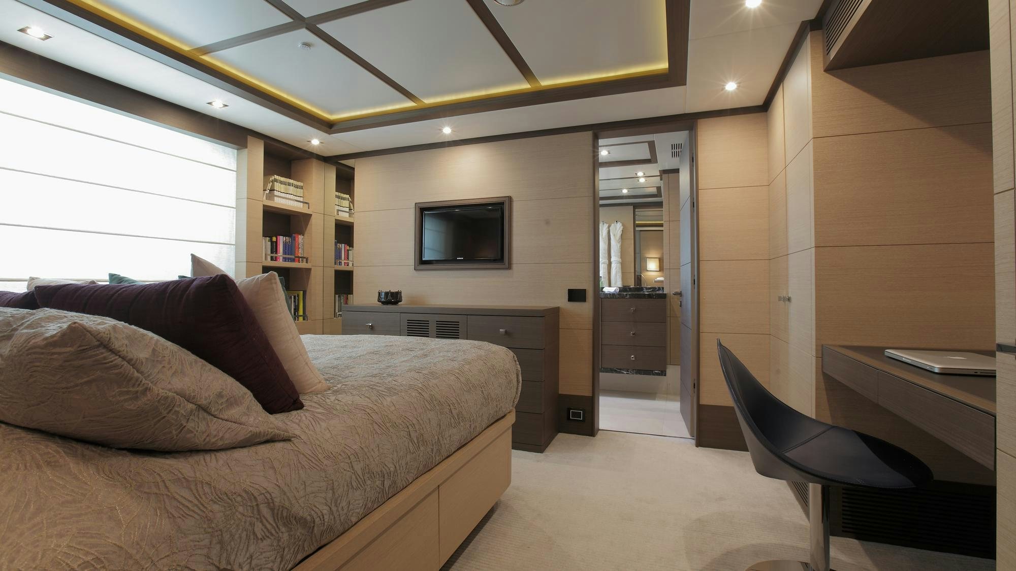 a bedroom with a bed and a tv aboard LATIKO Yacht for Charter