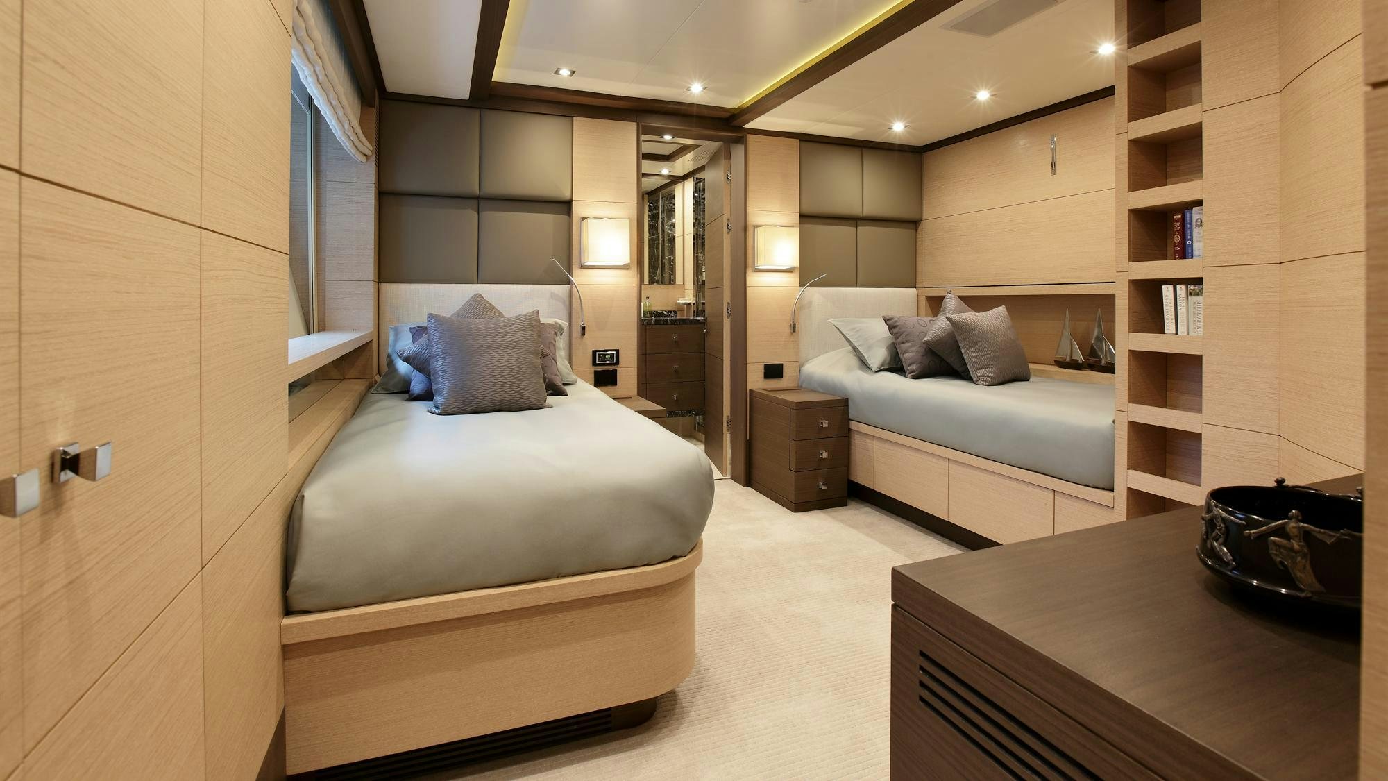 a room with a bed and a bookcase aboard LATIKO Yacht for Charter
