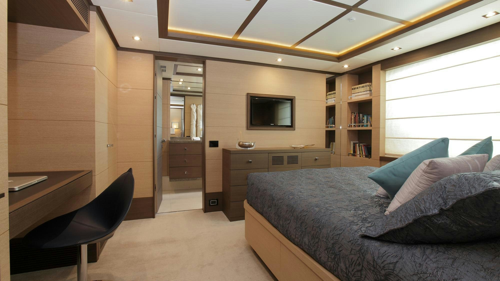 a bedroom with a bed and a tv aboard LATIKO Yacht for Charter